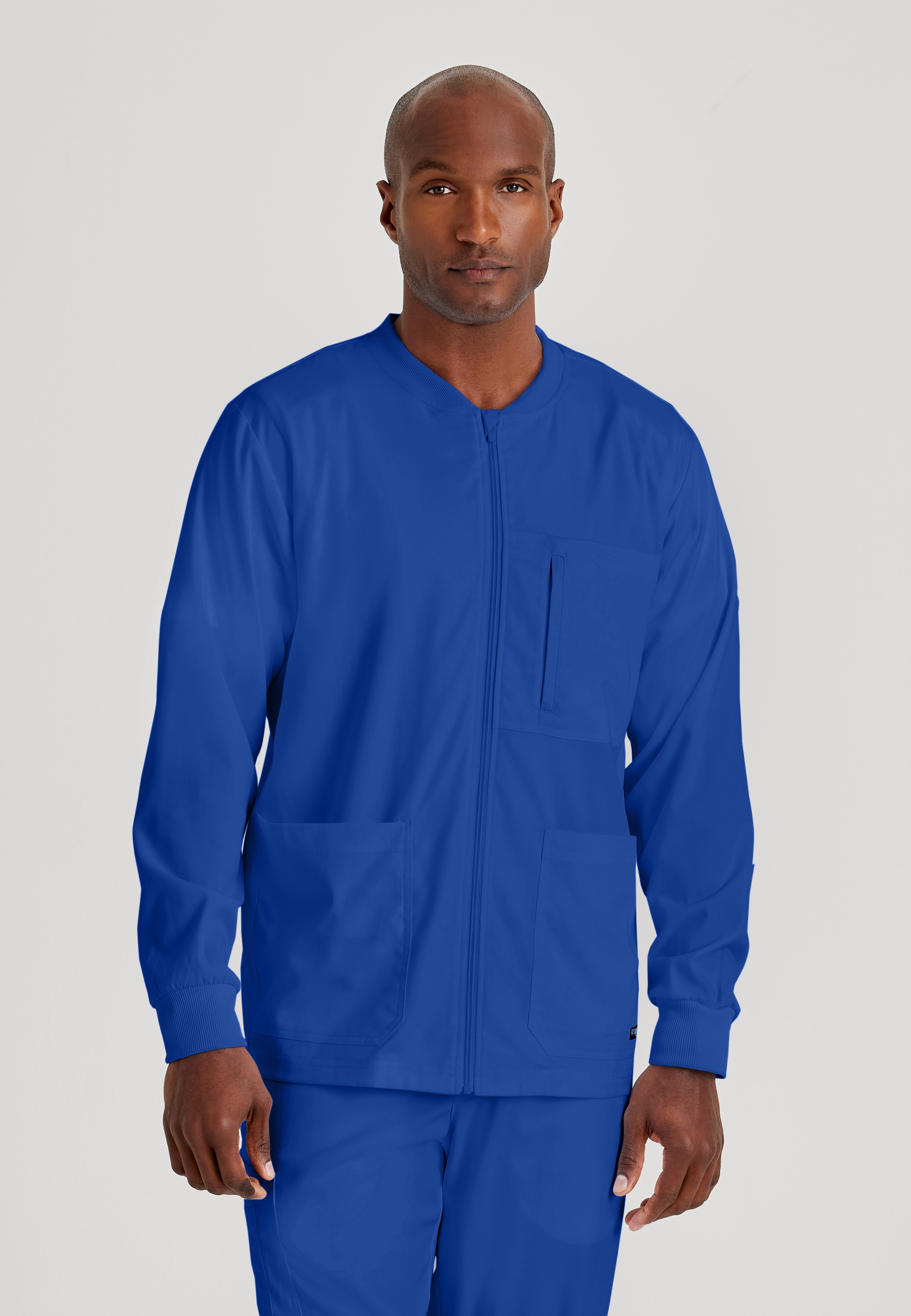 Front View of the React 5-Pocket Crewneck Warmup Scrub Jacket in Galaxy from Grey's Anatomy™ by Barco Spandex Stretch