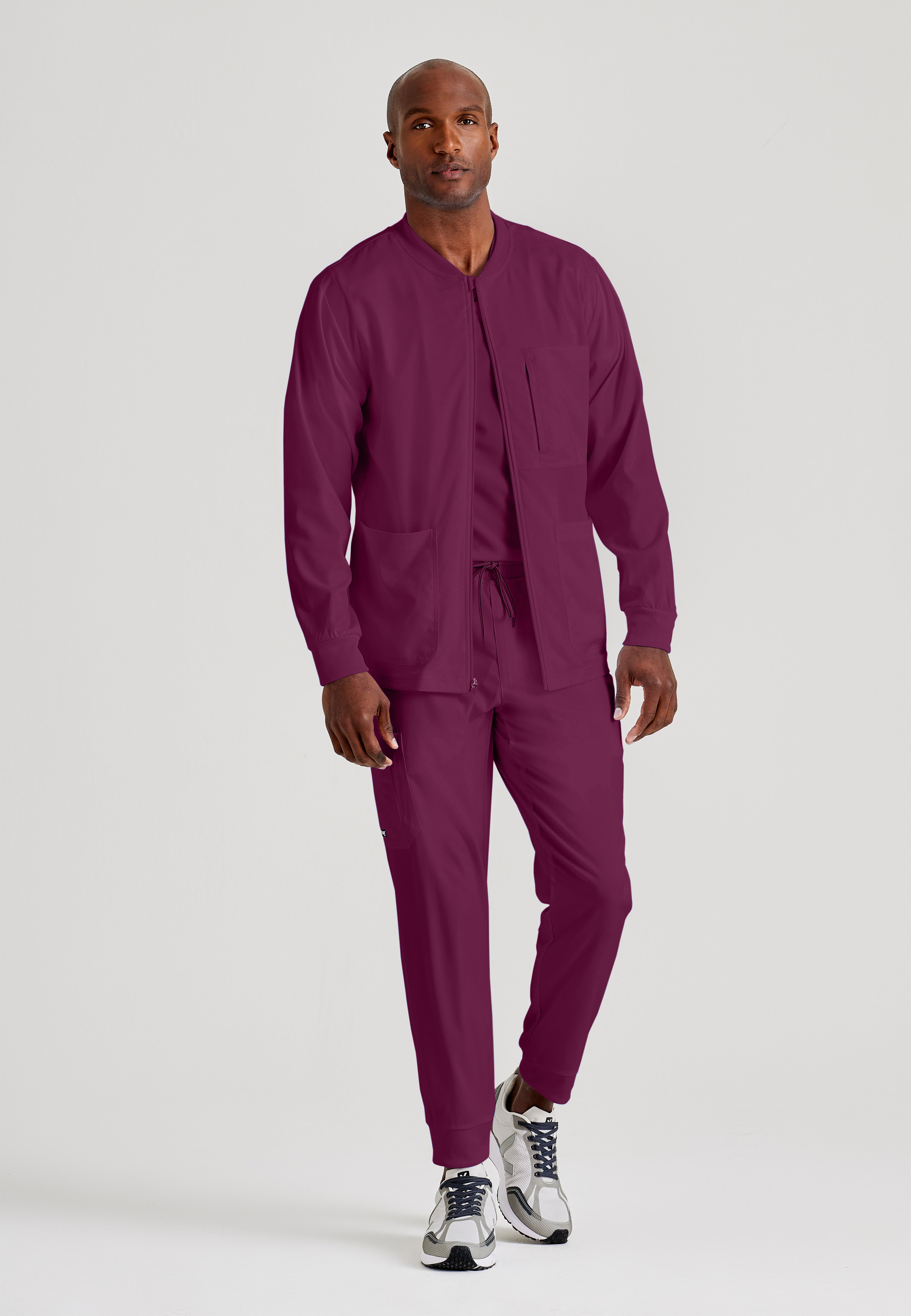 Full Body View of the React 5-Pocket Crewneck Warmup Scrub Jacket in Wine from Grey's Anatomy™ by Barco Spandex Stretch