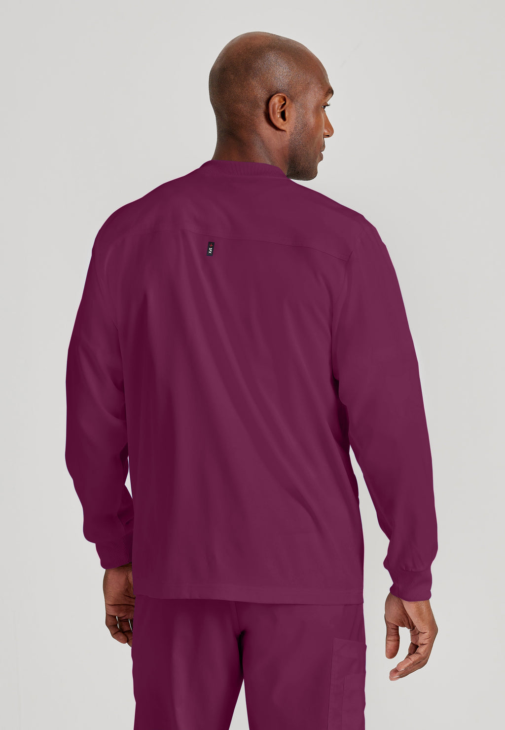 Back View of the React 5-Pocket Crewneck Warmup Scrub Jacket in Wine from Grey's Anatomy™ by Barco Spandex Stretch