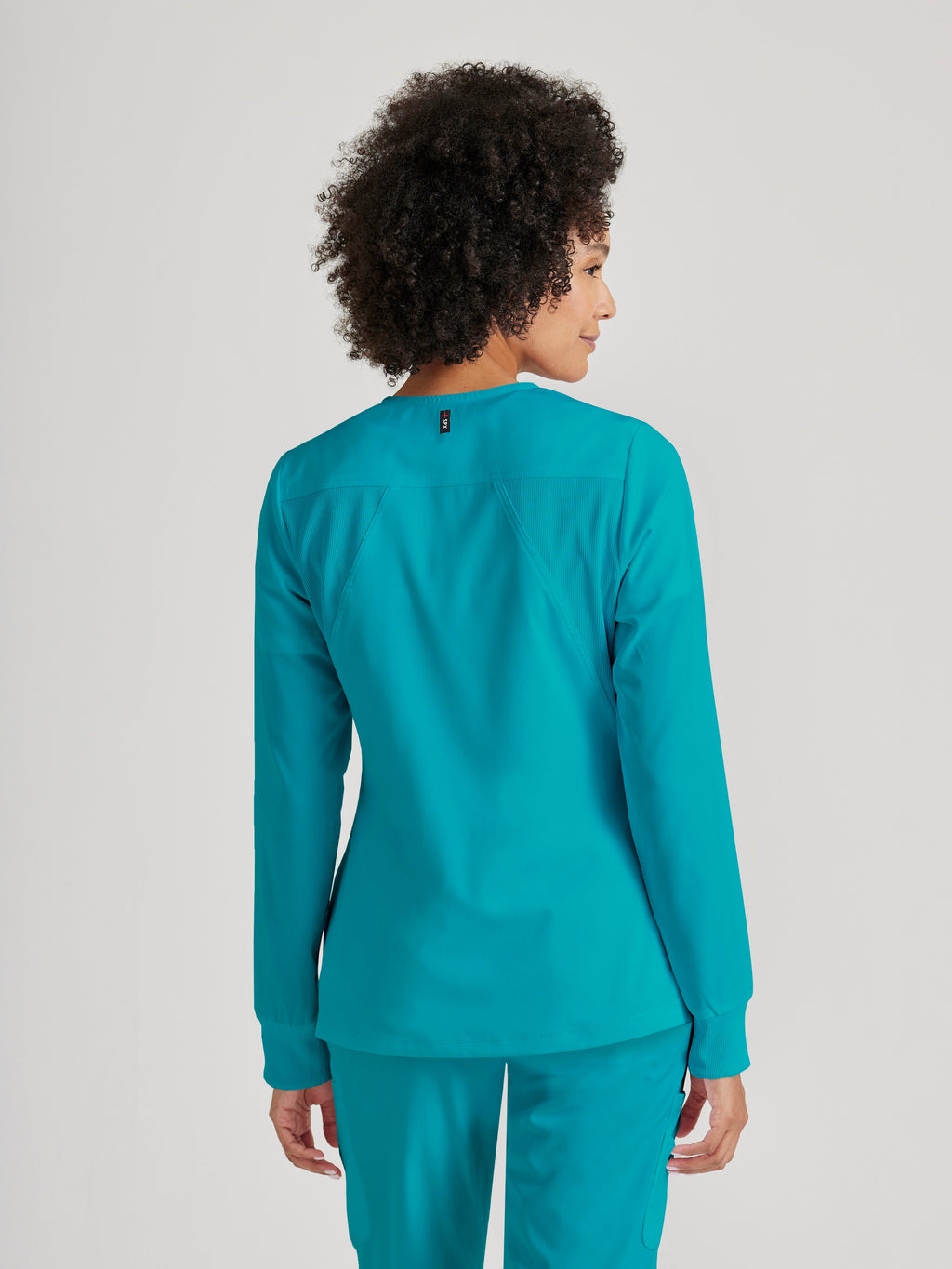 Grey's Anatomy Spandex-Stretch Women’s teal Warm-Up Scrub Jacket. Zip front round neck. 5 pockets. Rib cuff sleeve. 