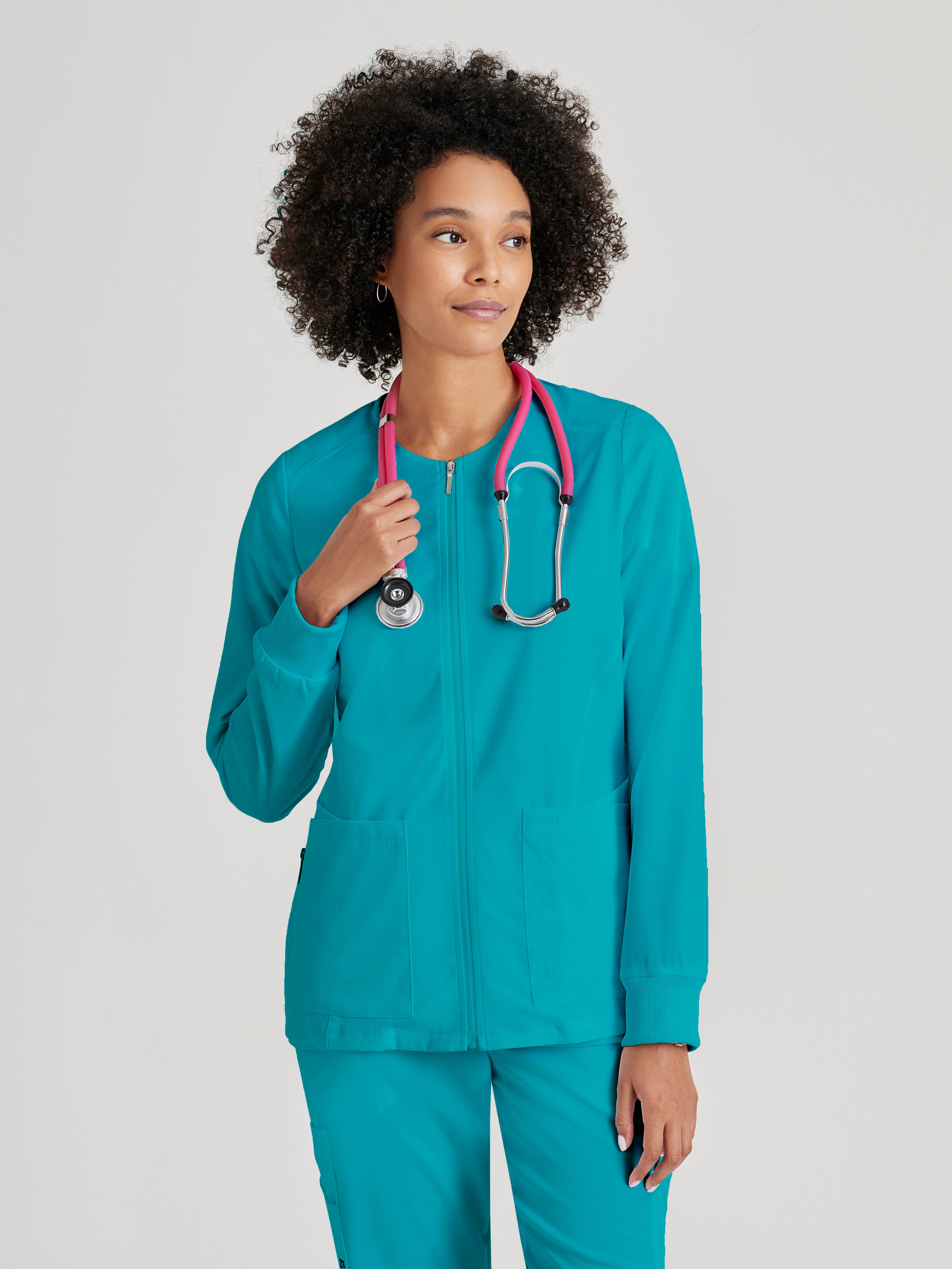 Grey's Anatomy Spandex-Stretch Women’s teal Warm-Up Scrub Jacket. Zip front round neck. 5 pockets. Rib cuff sleeve. 
