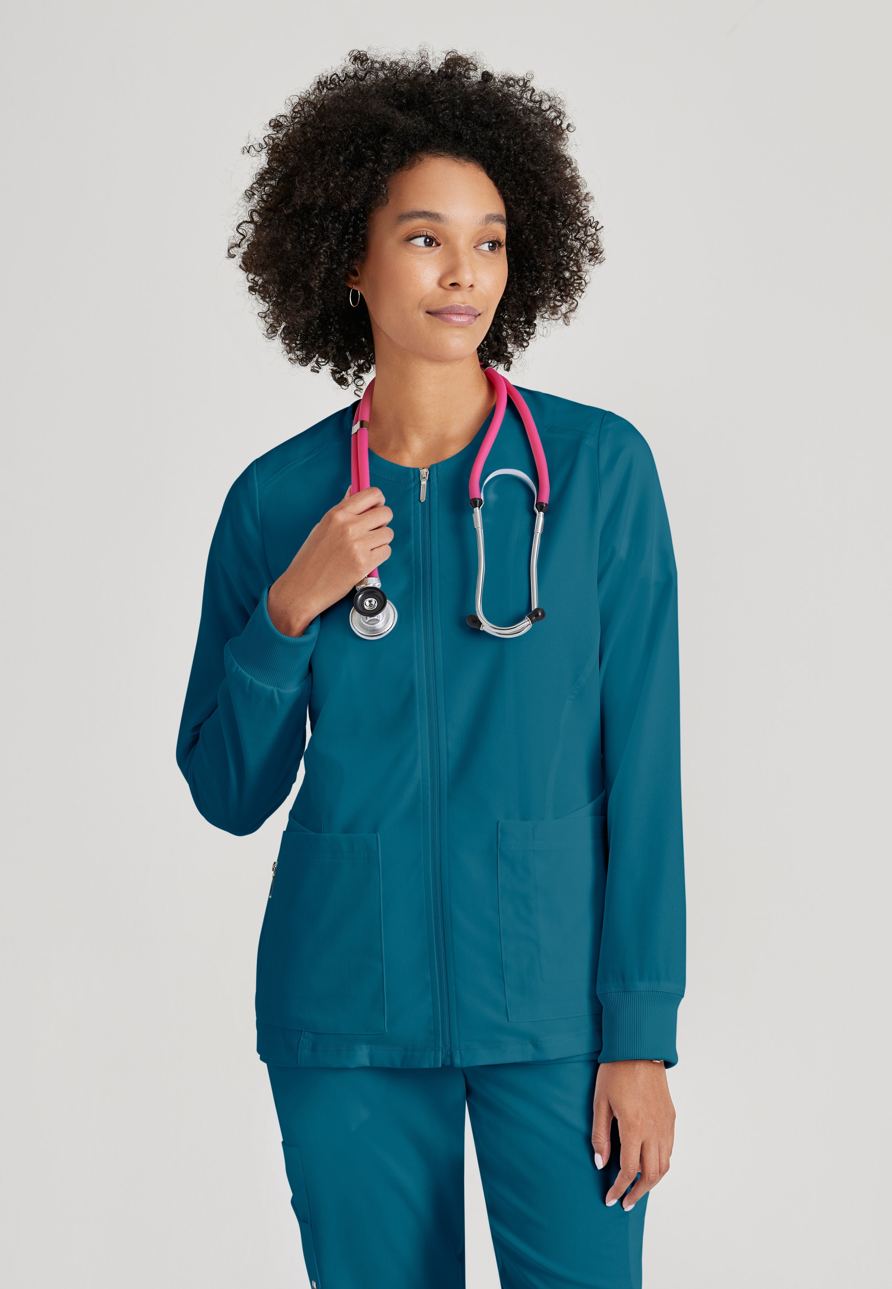 Grey's Anatomy Spandex-Stretch Women’s Bahama Warm-Up Scrub Jacket. Zip front round neck. 5 pockets. Rib cuff sleeve. 