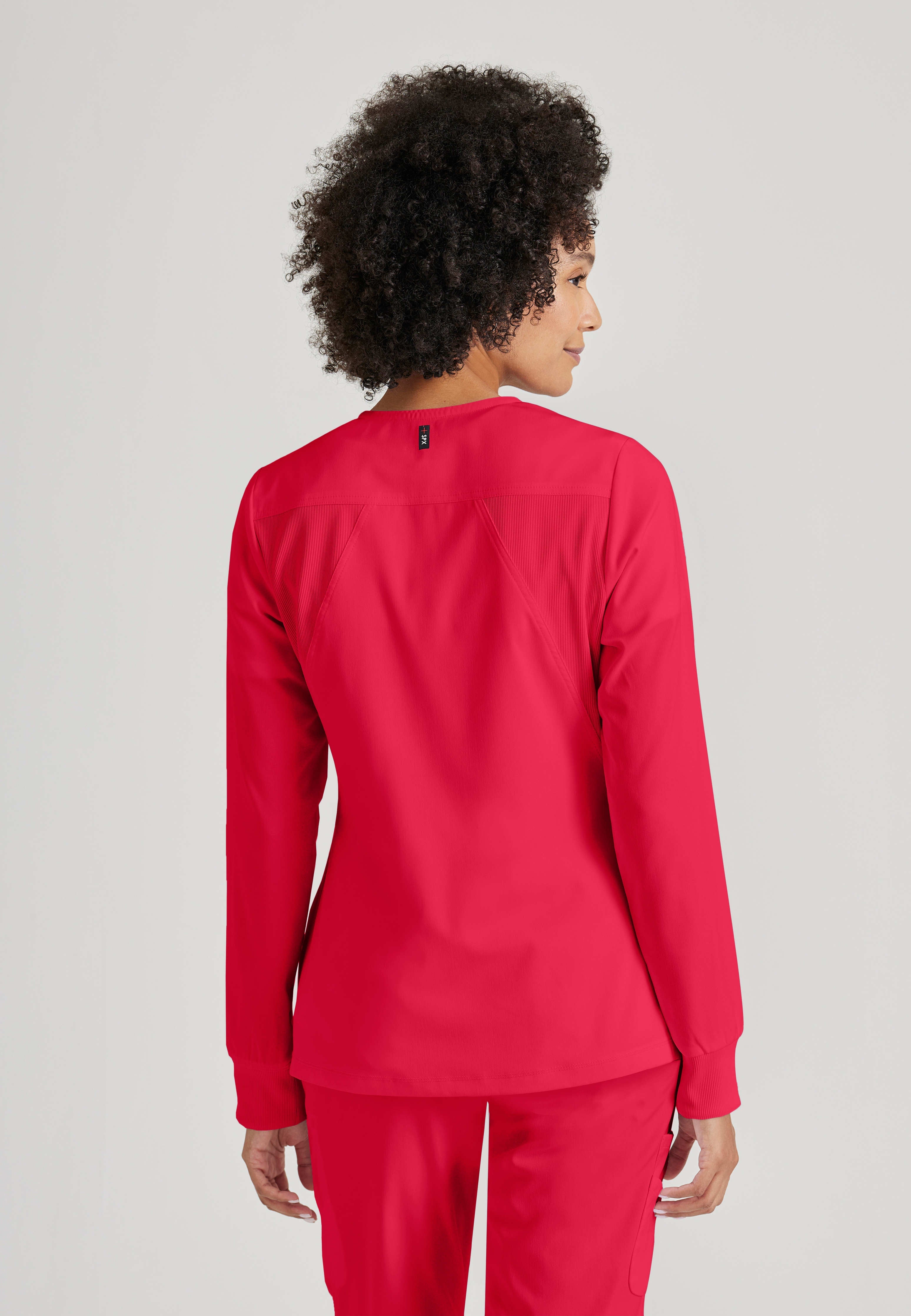 Side View of the Gianna 5-Pocket Crewneck Scrub Jacket in Scarlet Red from Grey's Anatomy™ by Barco Spandex Stretch