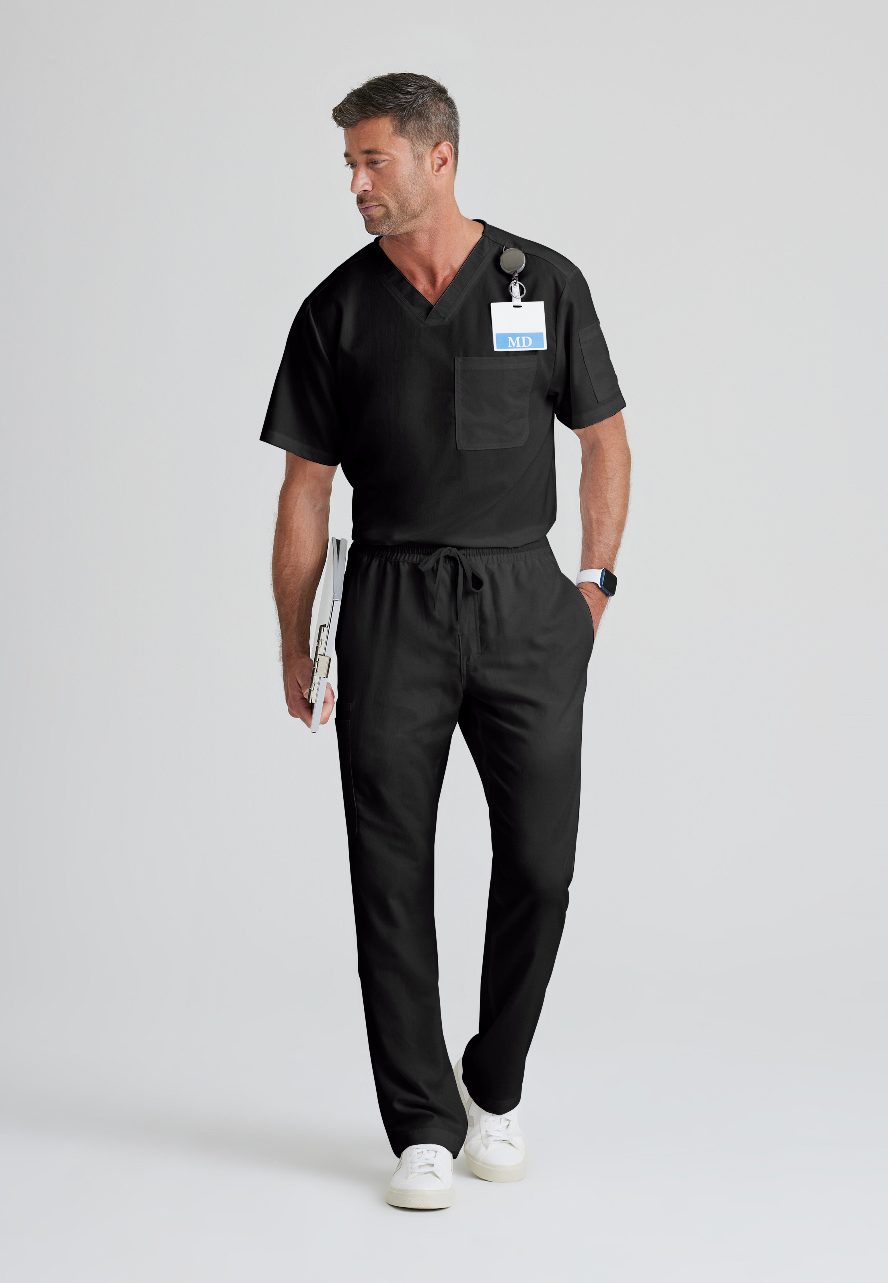Full Body View of the Evan 2-Pocket V-Neck Scrub Top in Black from Grey's Anatomy™ by Barco Classic