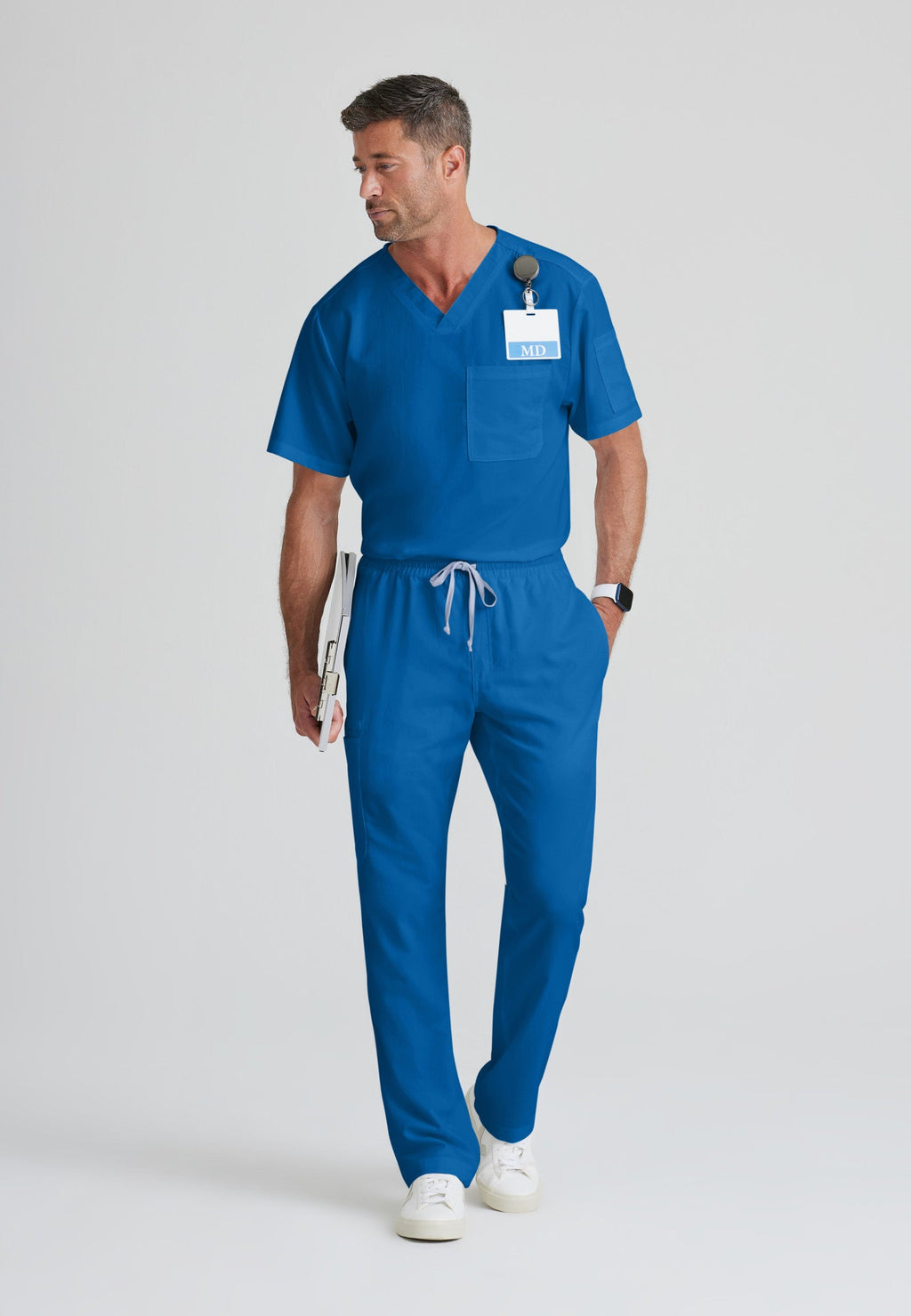 Full Body View of the Evan 2-Pocket V-Neck Scrub Top in New Royal from Grey's Anatomy™ by Barco Classic
