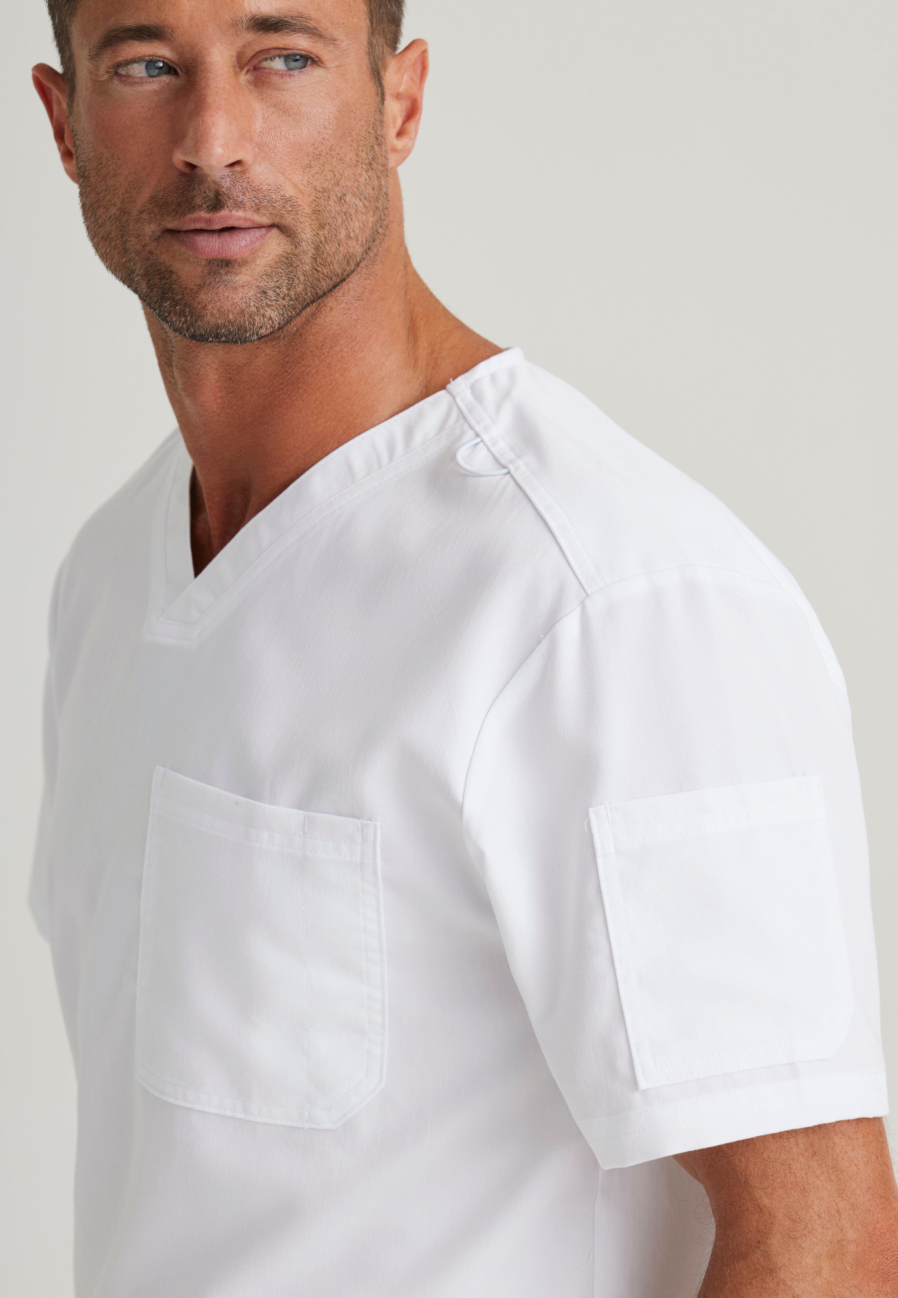Detail Shot of the Evan 2-Pocket V-Neck Scrub Top in White from Grey's Anatomy™ by Barco Classic