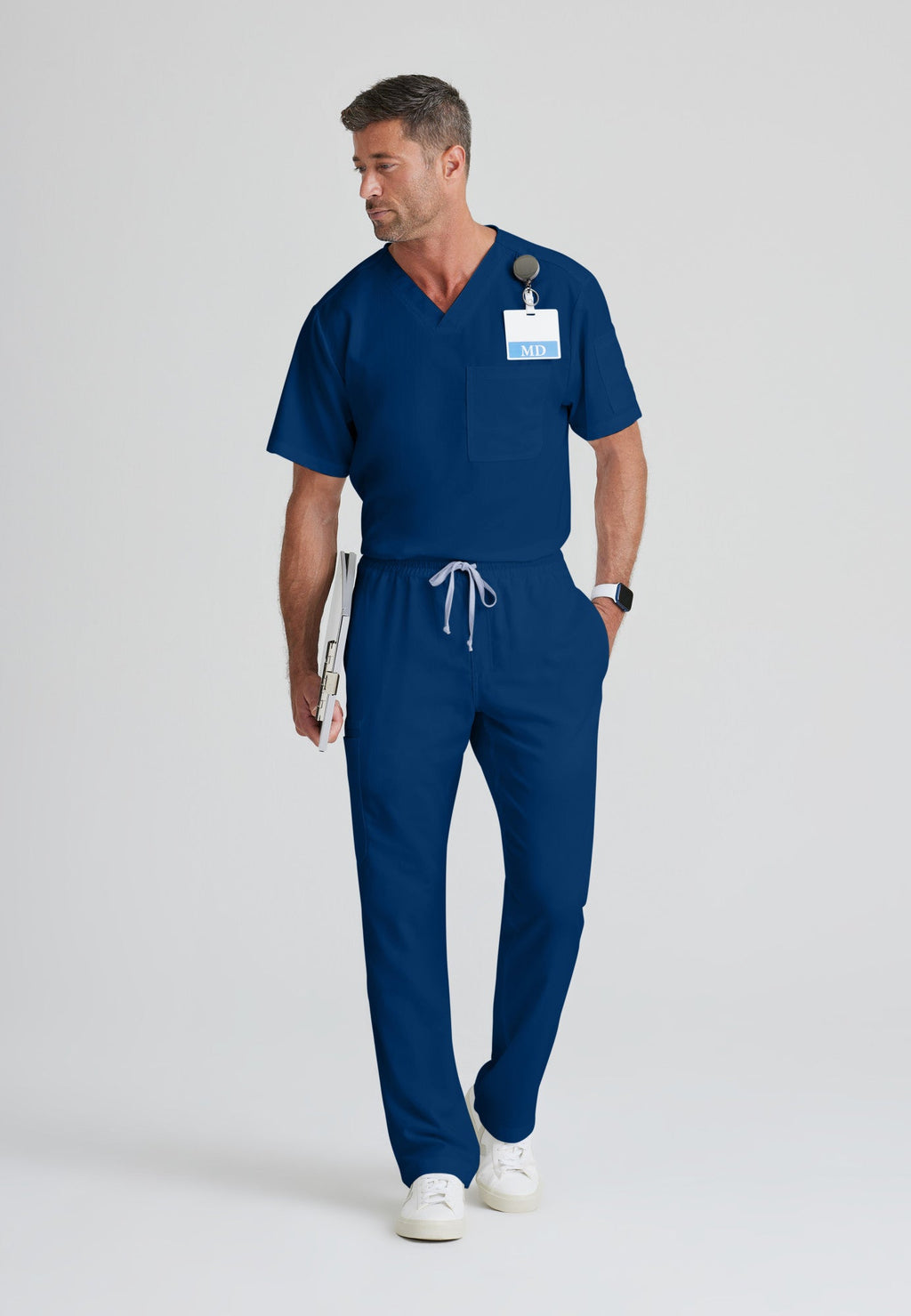 Full Body View of the Evan 2-Pocket V-Neck Scrub Top in Indigo from Grey's Anatomy™ by Barco Classic