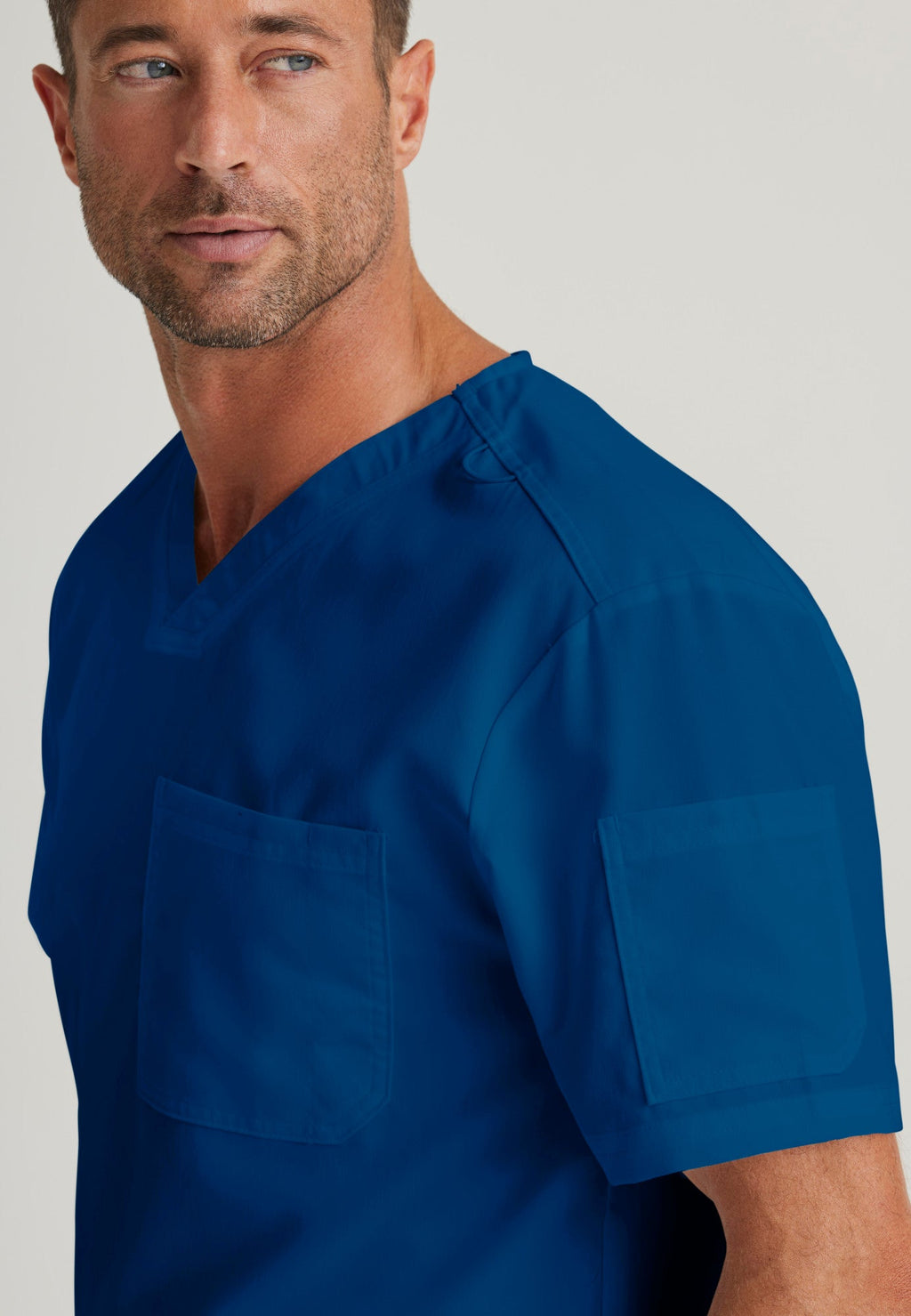 Detail Shot of the Evan 2-Pocket V-Neck Scrub Top in Indigo from Grey's Anatomy™ by Barco Classic