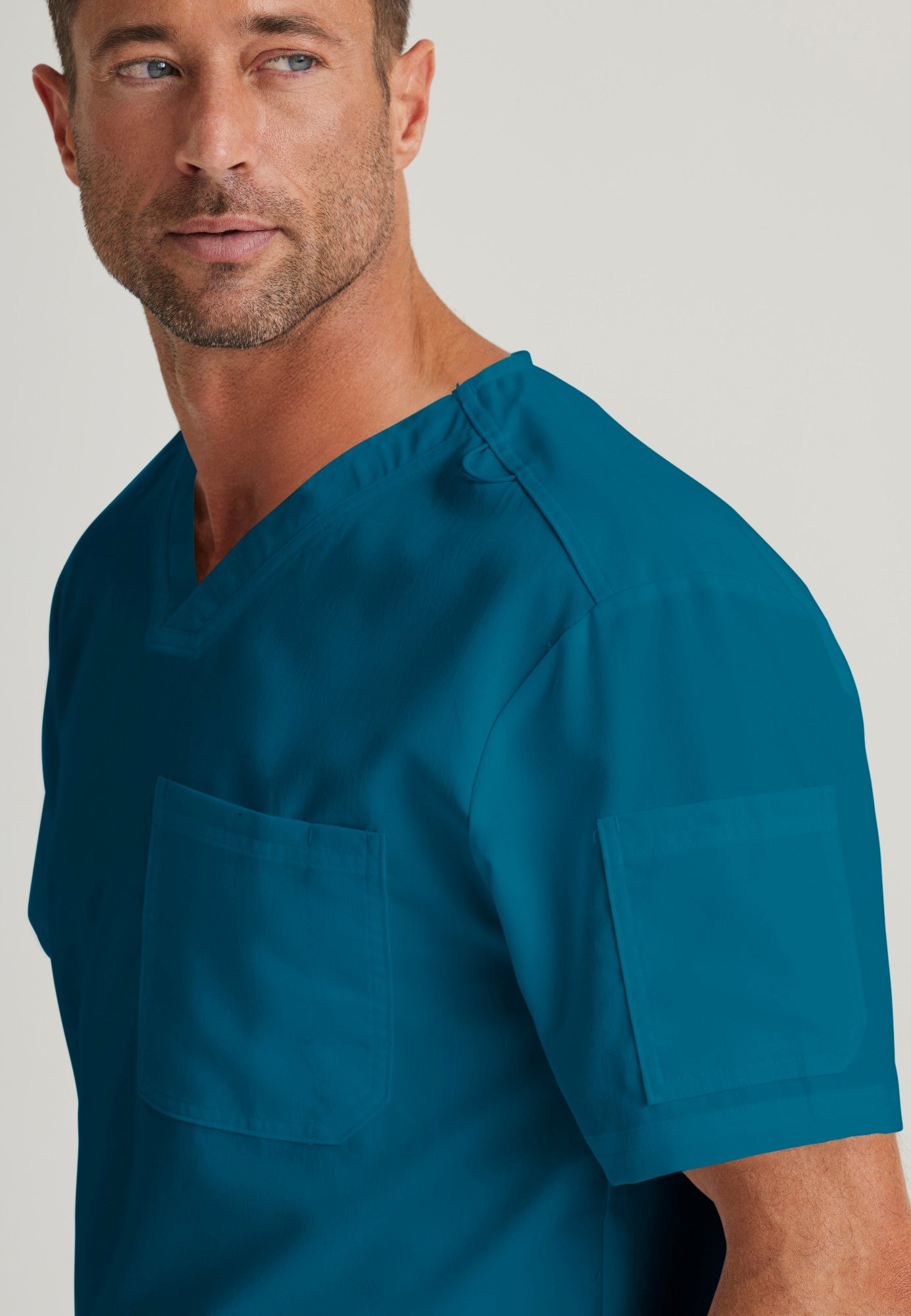 Detail Shot of the Evan 2-Pocket V-Neck Scrub Top in Bahama from Grey's Anatomy™ by Barco Classic