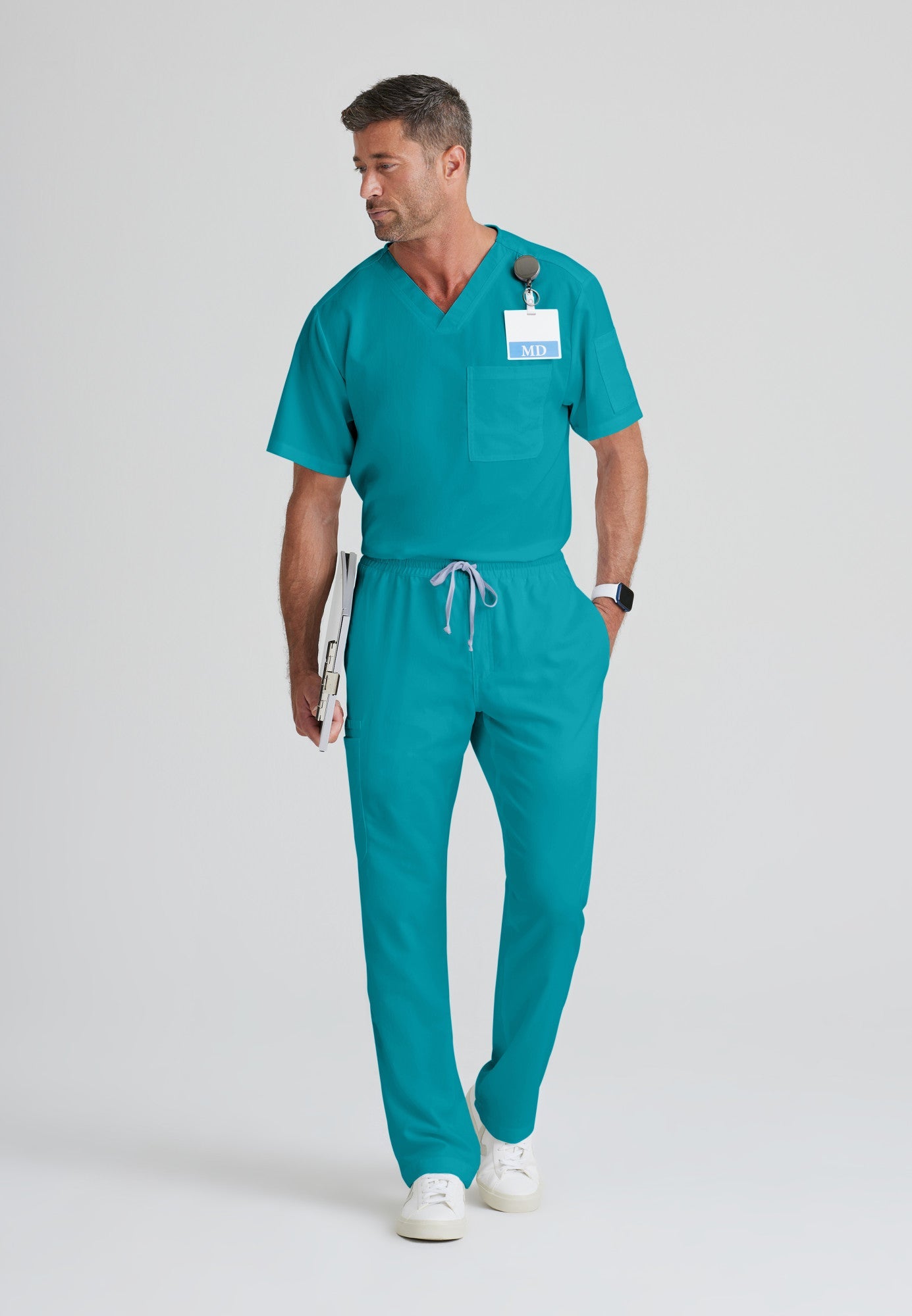 Full Body View of the Evan 2-Pocket V-Neck Scrub Top in Teal from Grey's Anatomy™ by Barco Classic