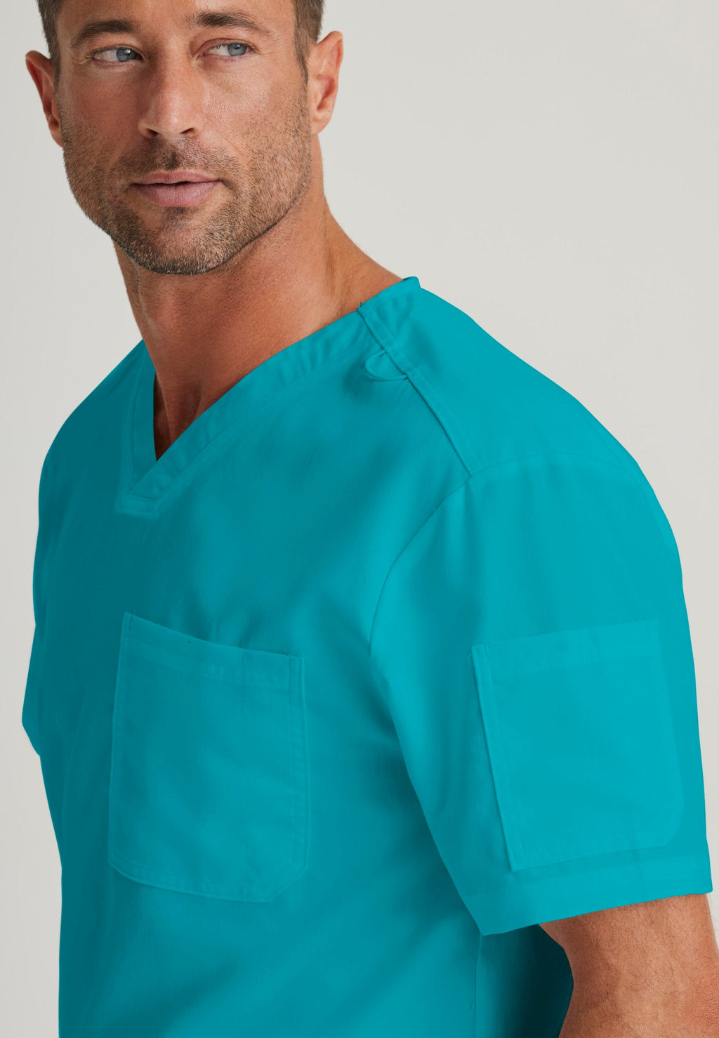 Detail Shot of the Evan 2-Pocket V-Neck Scrub Top in Teal from Grey's Anatomy™ by Barco Classic