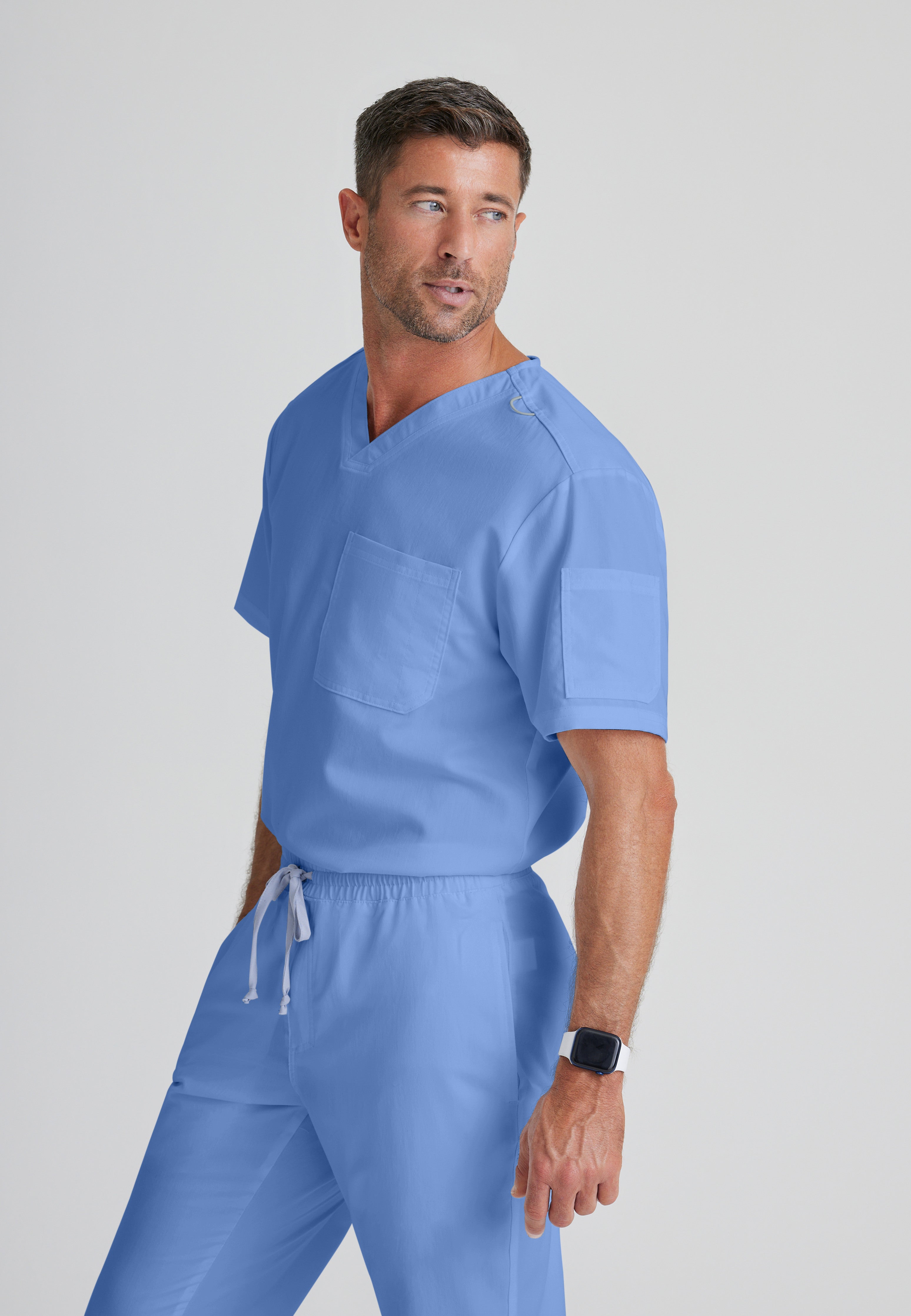Side View of the Evan 2-Pocket V-Neck Scrub Top in Ciel Blue from Grey's Anatomy™ by Barco Classic
