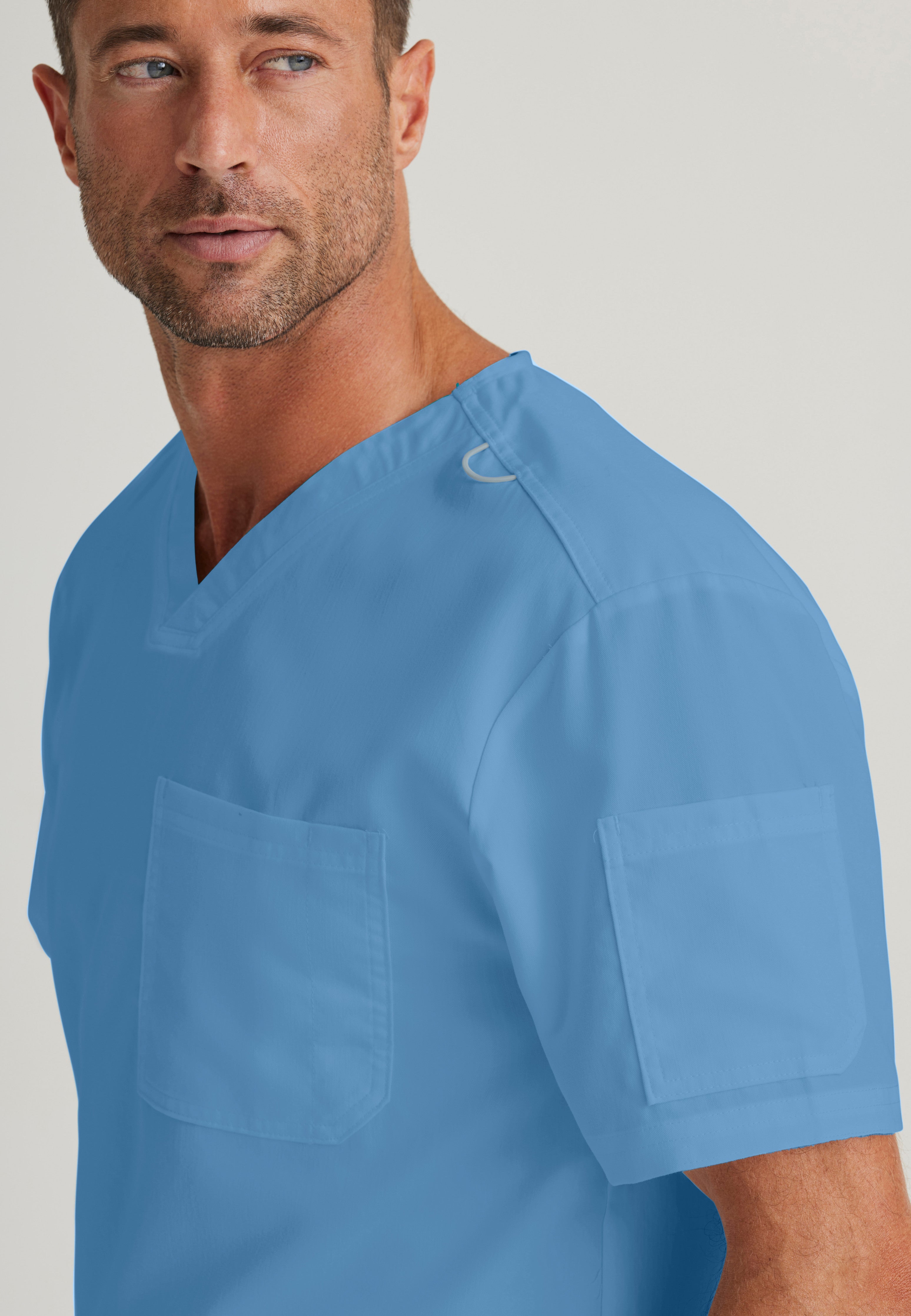 Detail Shot of the Evan 2-Pocket V-Neck Scrub Top in Ciel Blue from Grey's Anatomy™ by Barco Classic