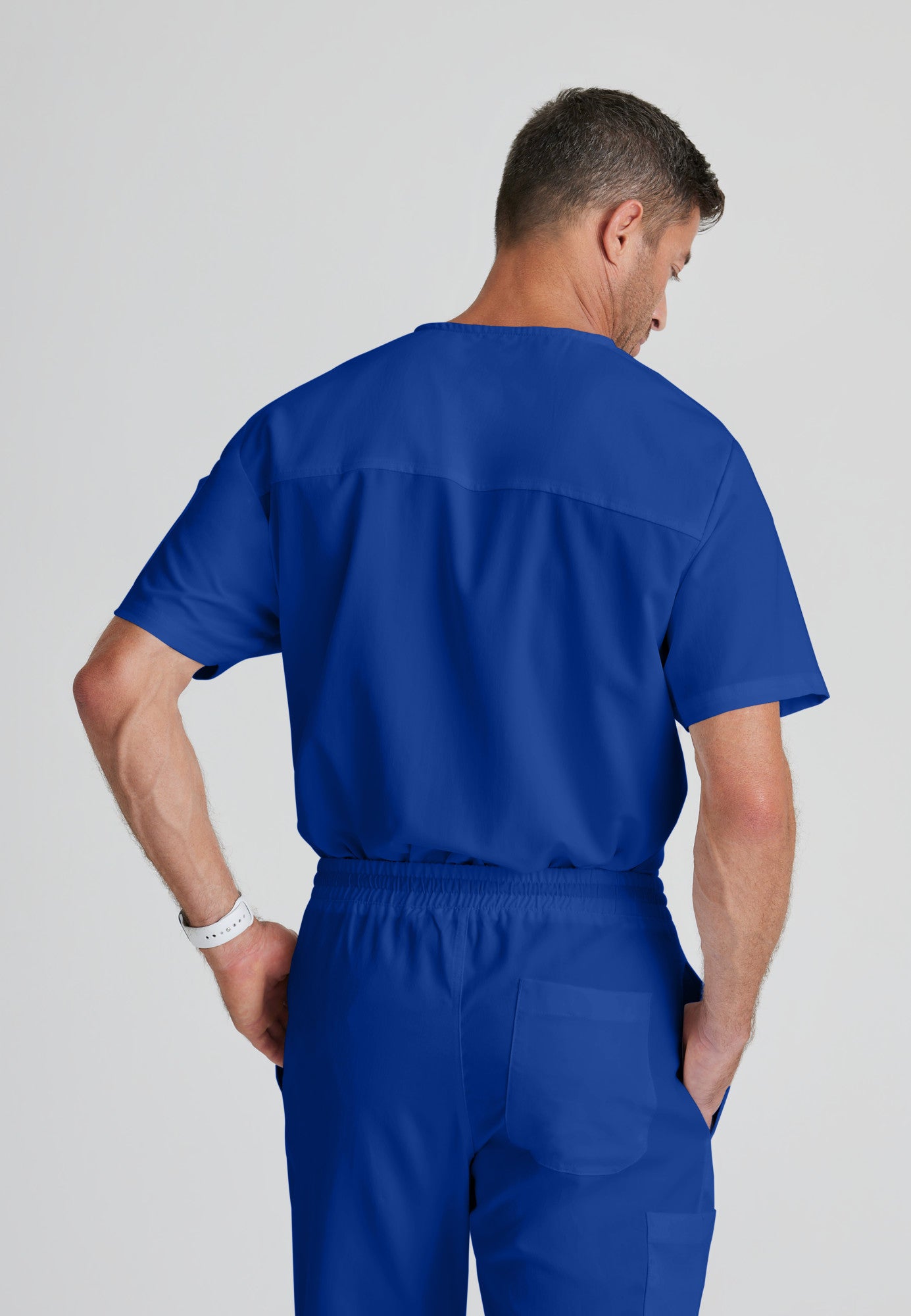 Back View of the Evan 2-Pocket V-Neck Scrub Top in Galaxy from Grey's Anatomy™ by Barco Classic