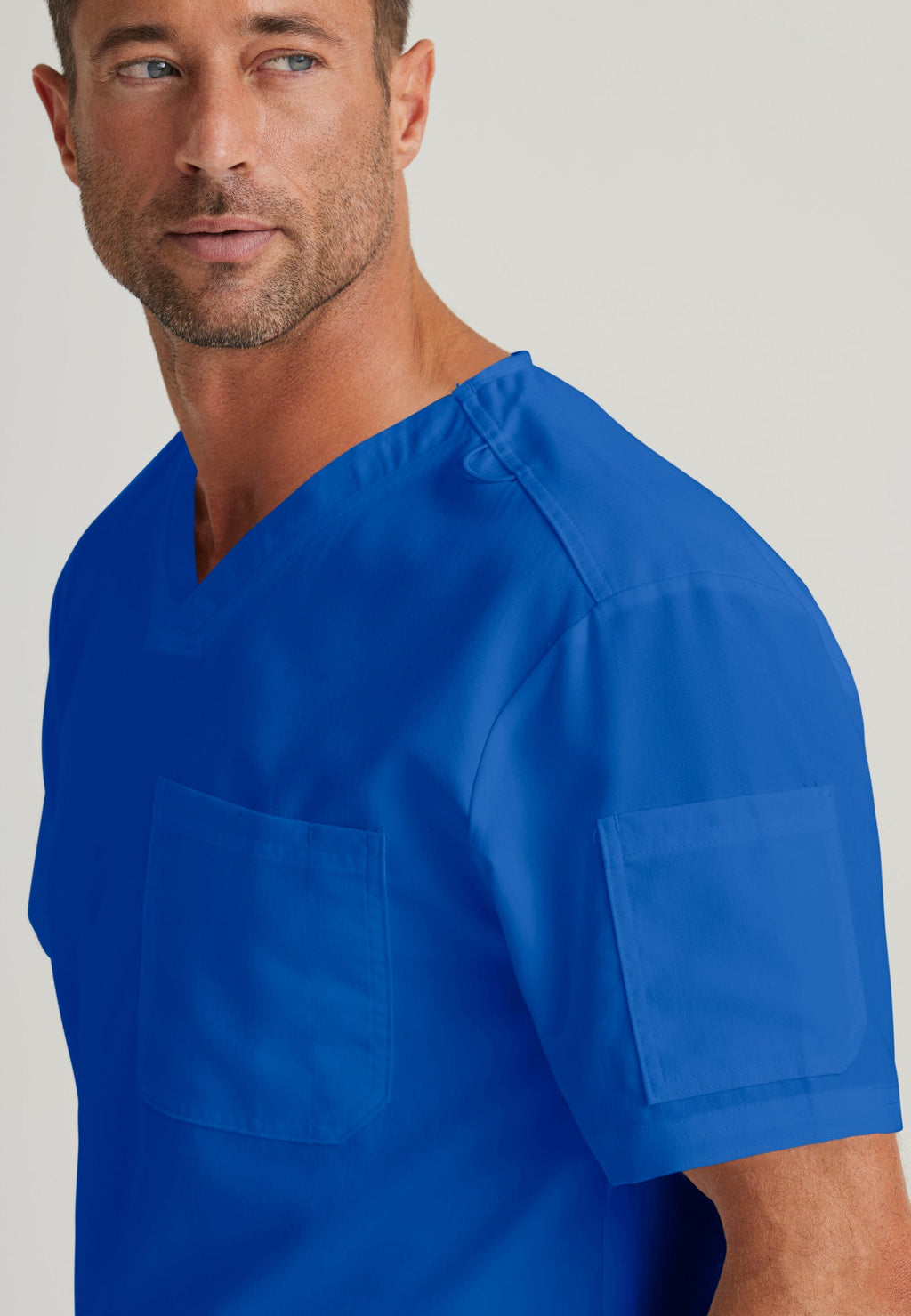 Detail Shot of the Evan 2-Pocket V-Neck Scrub Top in Galaxy from Grey's Anatomy™ by Barco Classic