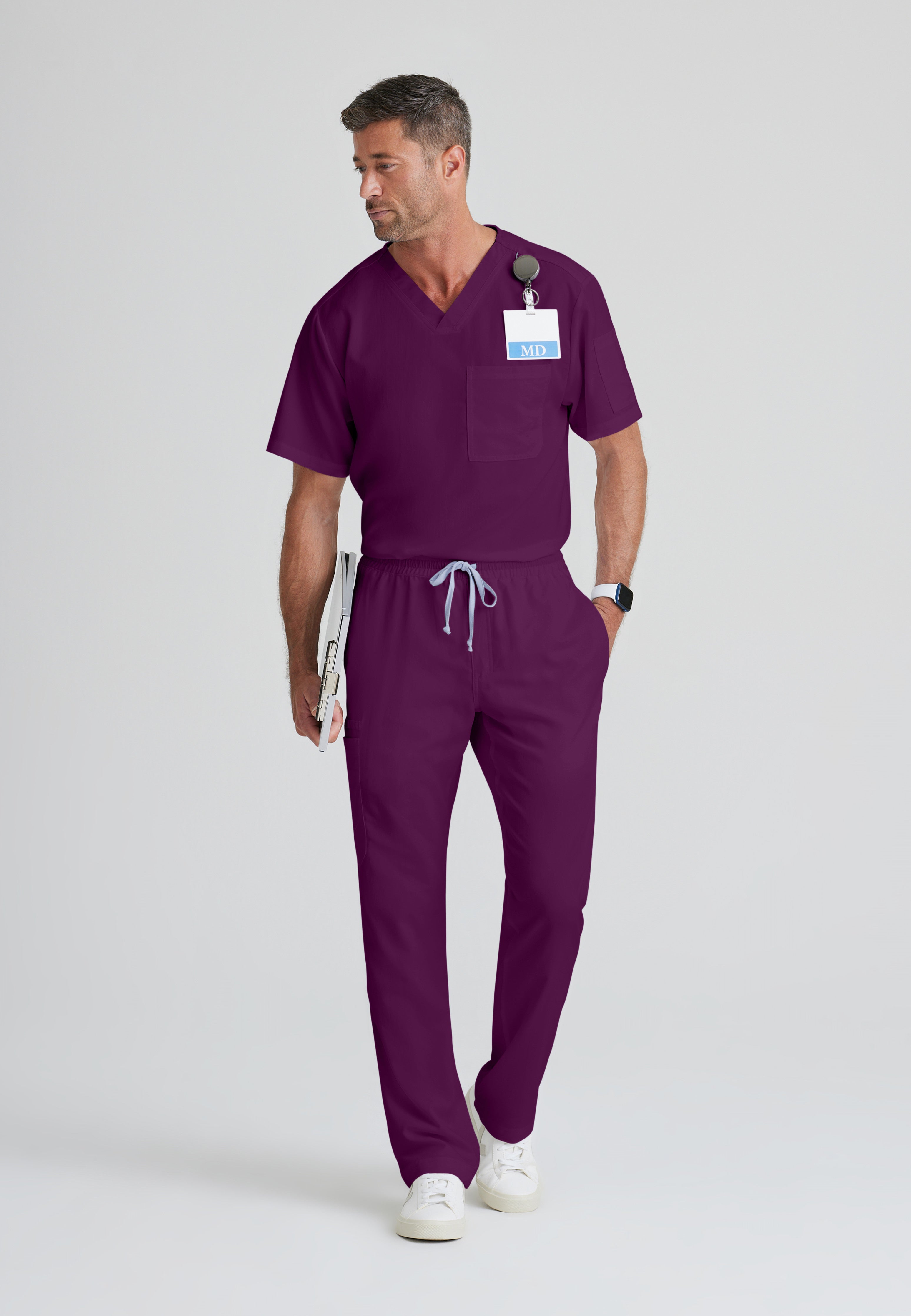 Full Body View of the Evan 2-Pocket V-Neck Scrub Top in Wine from Grey's Anatomy™ by Barco Classic