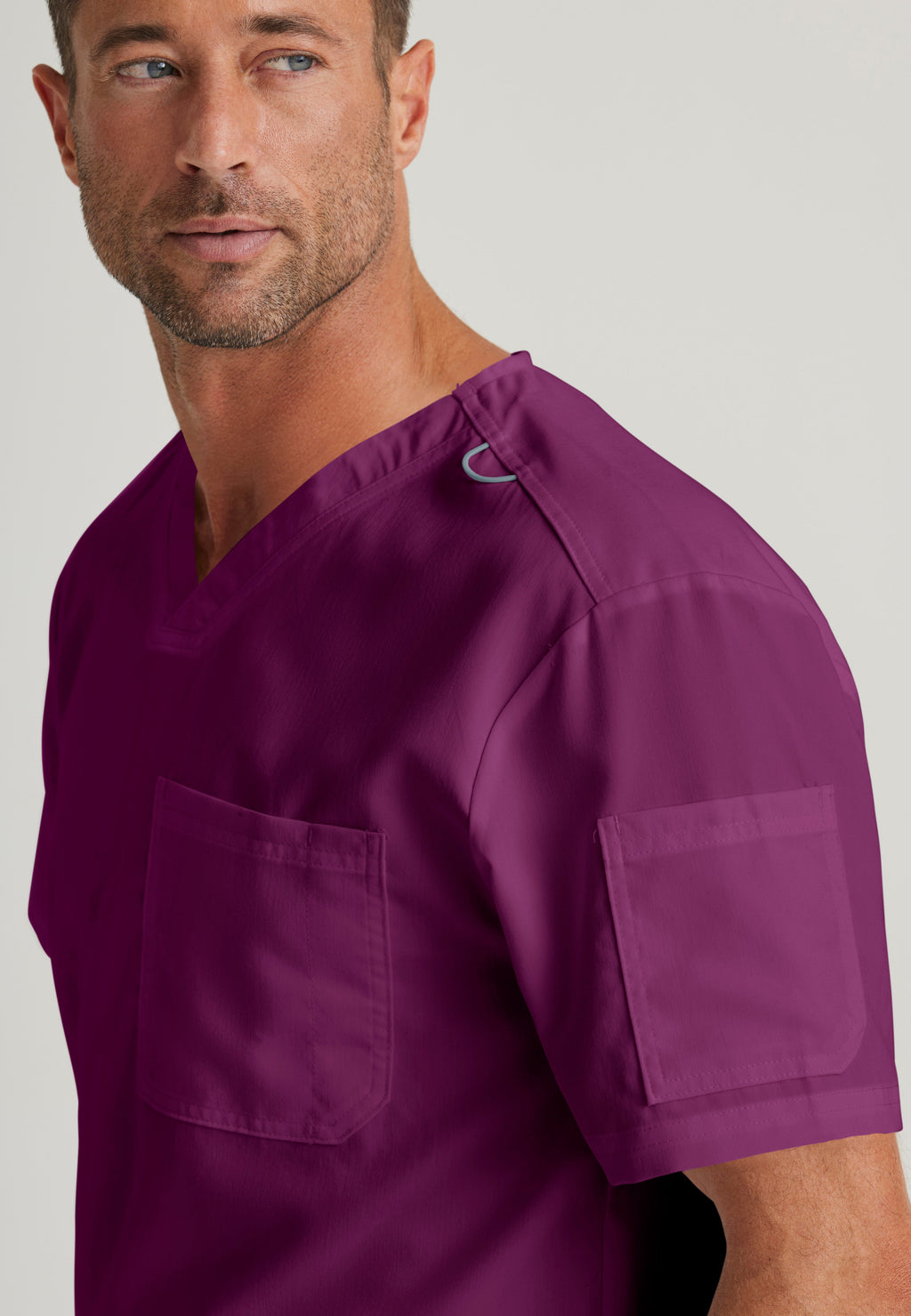 Detail Shot of the Evan 2-Pocket V-Neck Scrub Top in Wine from Grey's Anatomy™ by Barco Classic