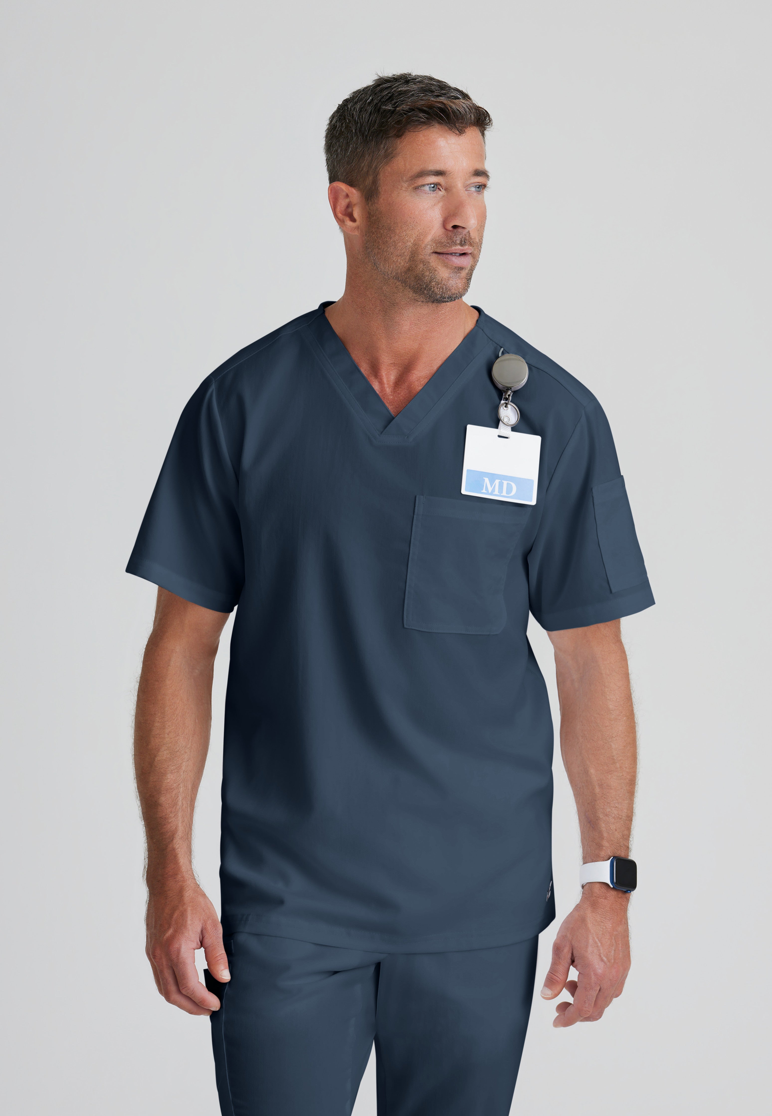 Front View of the Evan 2-Pocket V-Neck Scrub Top in Steel from Grey's Anatomy™ by Barco Classic
