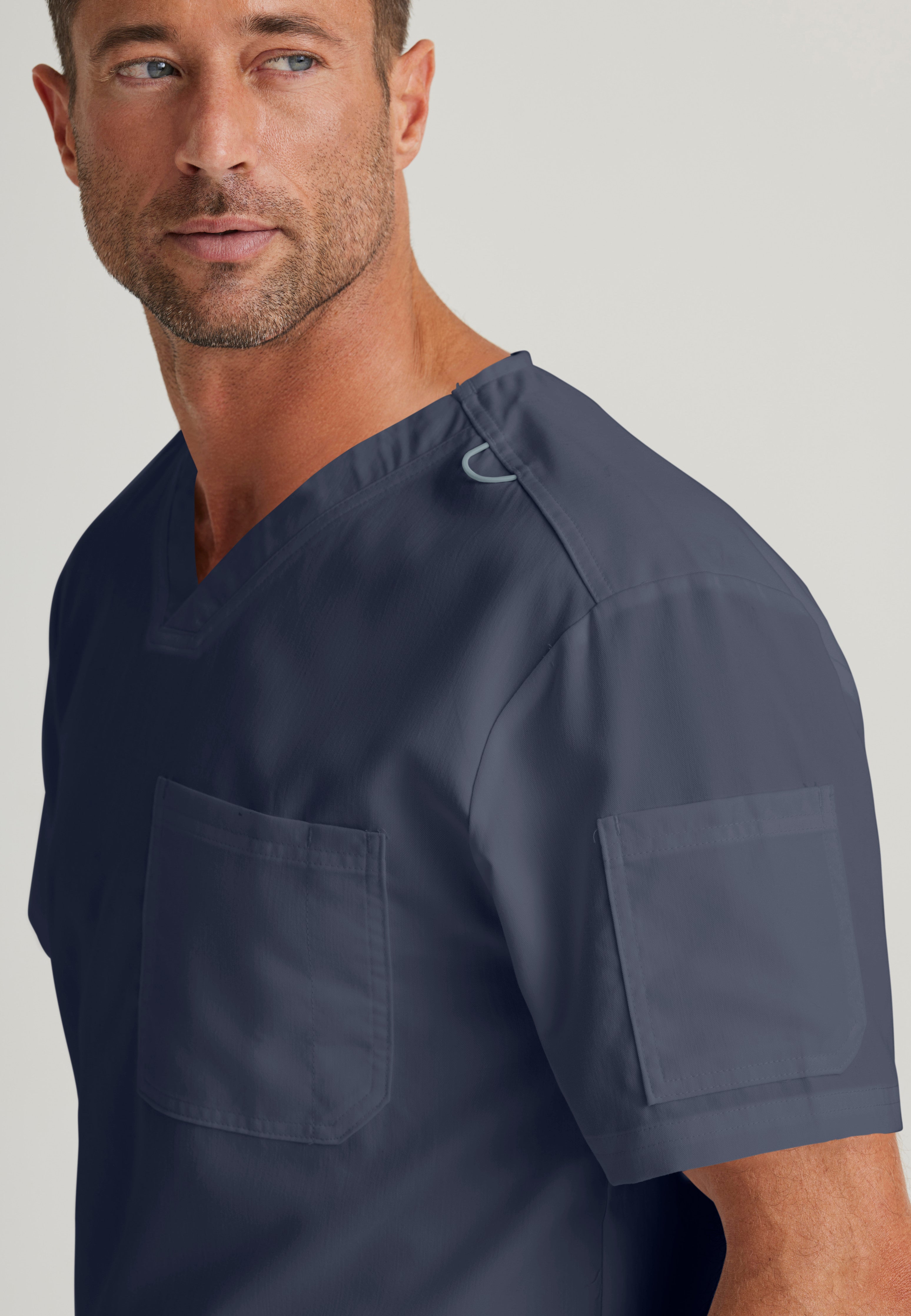 Detail Shot of the Evan 2-Pocket V-Neck Scrub Top in Steel from Grey's Anatomy™ by Barco Classic