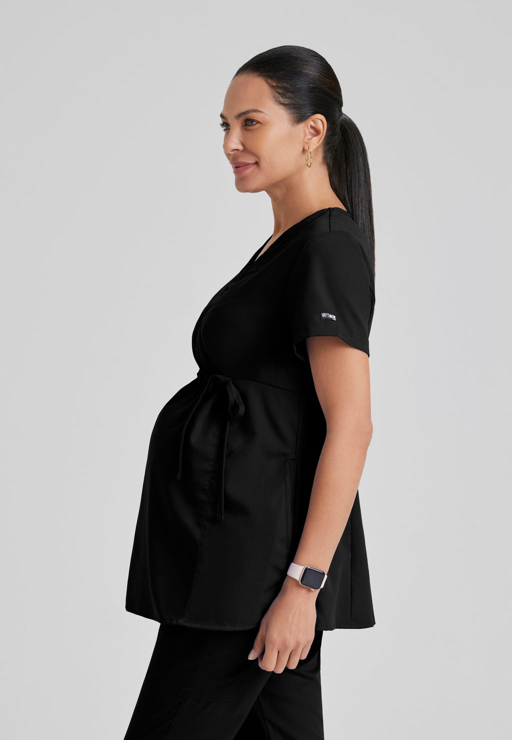 Side View of the Lilah 2-Pocket Mock Wrap Maternity Scrub Top in Black from Grey's Anatomy™ by Barco Classic