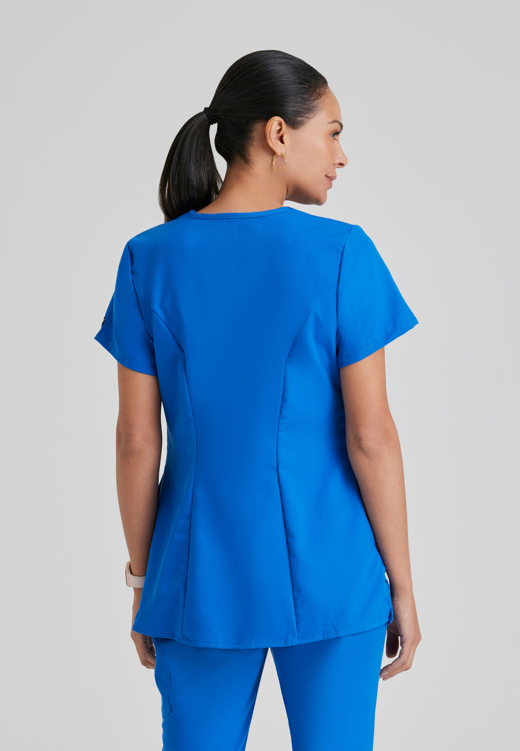 Back View of the Lilah 2-Pocket Mock Wrap Maternity Scrub Top in New Royal from Grey's Anatomy™ by Barco Classic