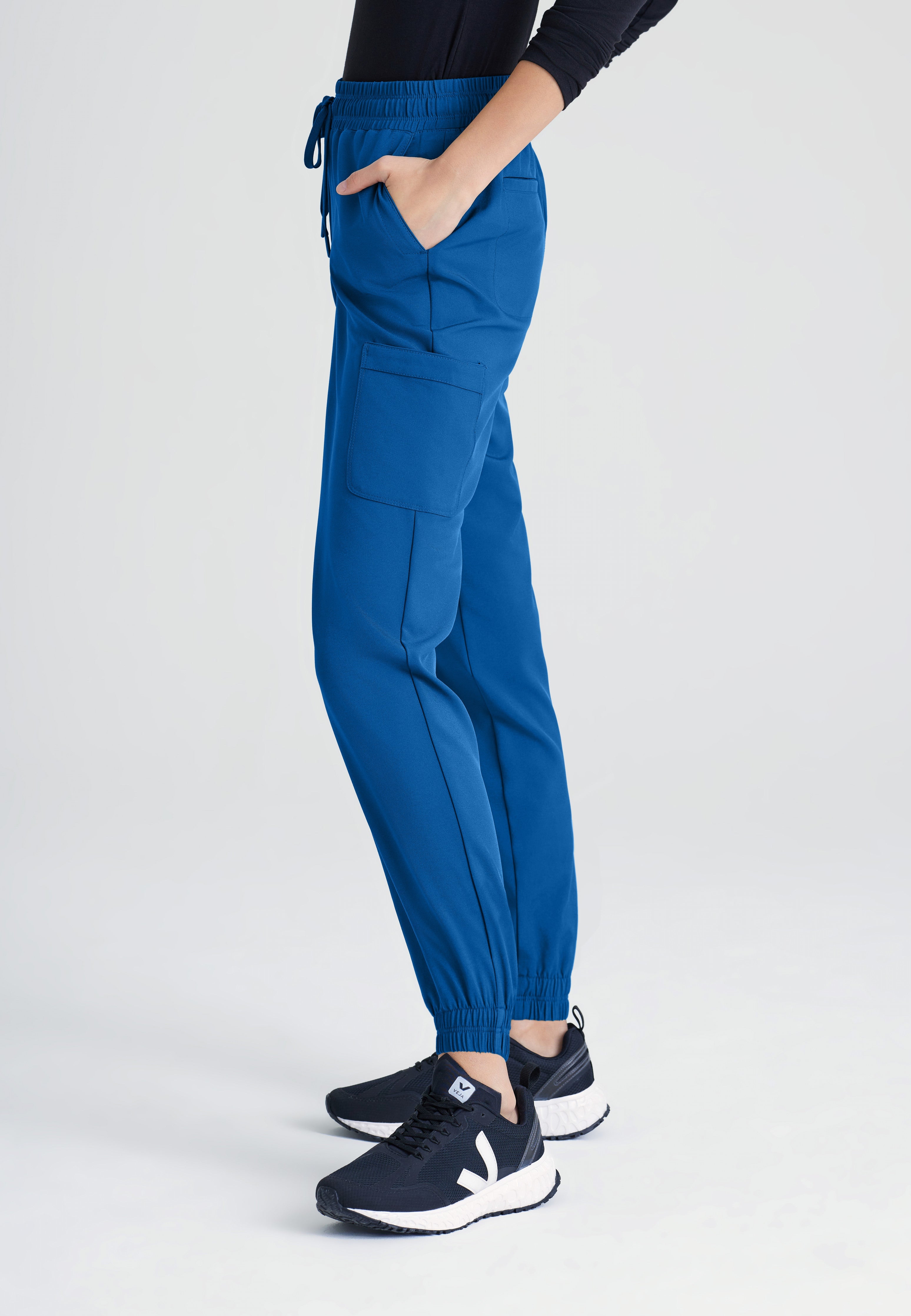 Side View of the Terra 6-Pocket Mid-Rise Ciclo® Jogger Scrub Pant in New Royal from Grey's Anatomy™ by Barco Evolve