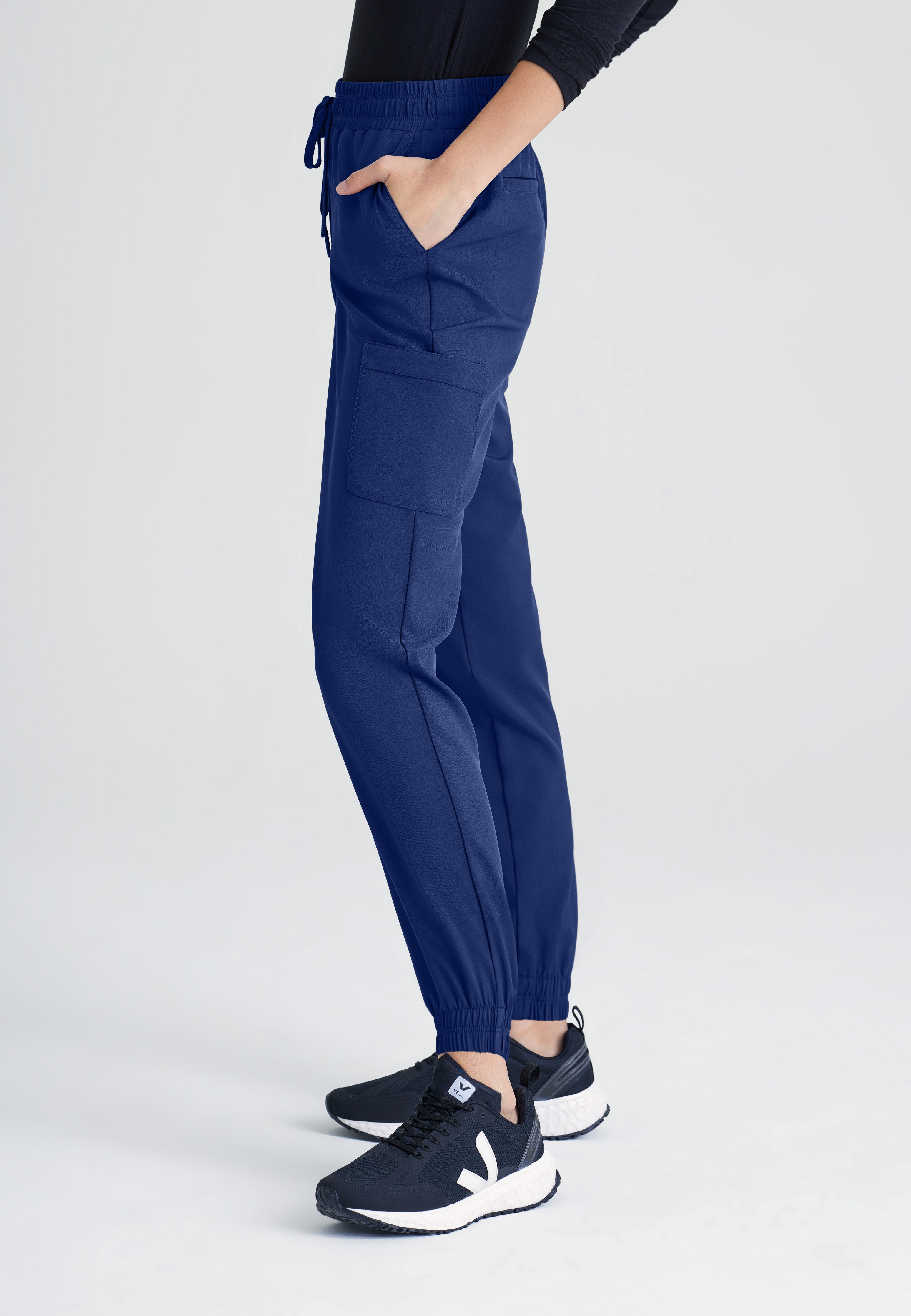 Side View of the Terra 6-Pocket Mid-Rise Ciclo® Jogger Scrub Pant in Indigo from Grey's Anatomy™ by Barco Evolve