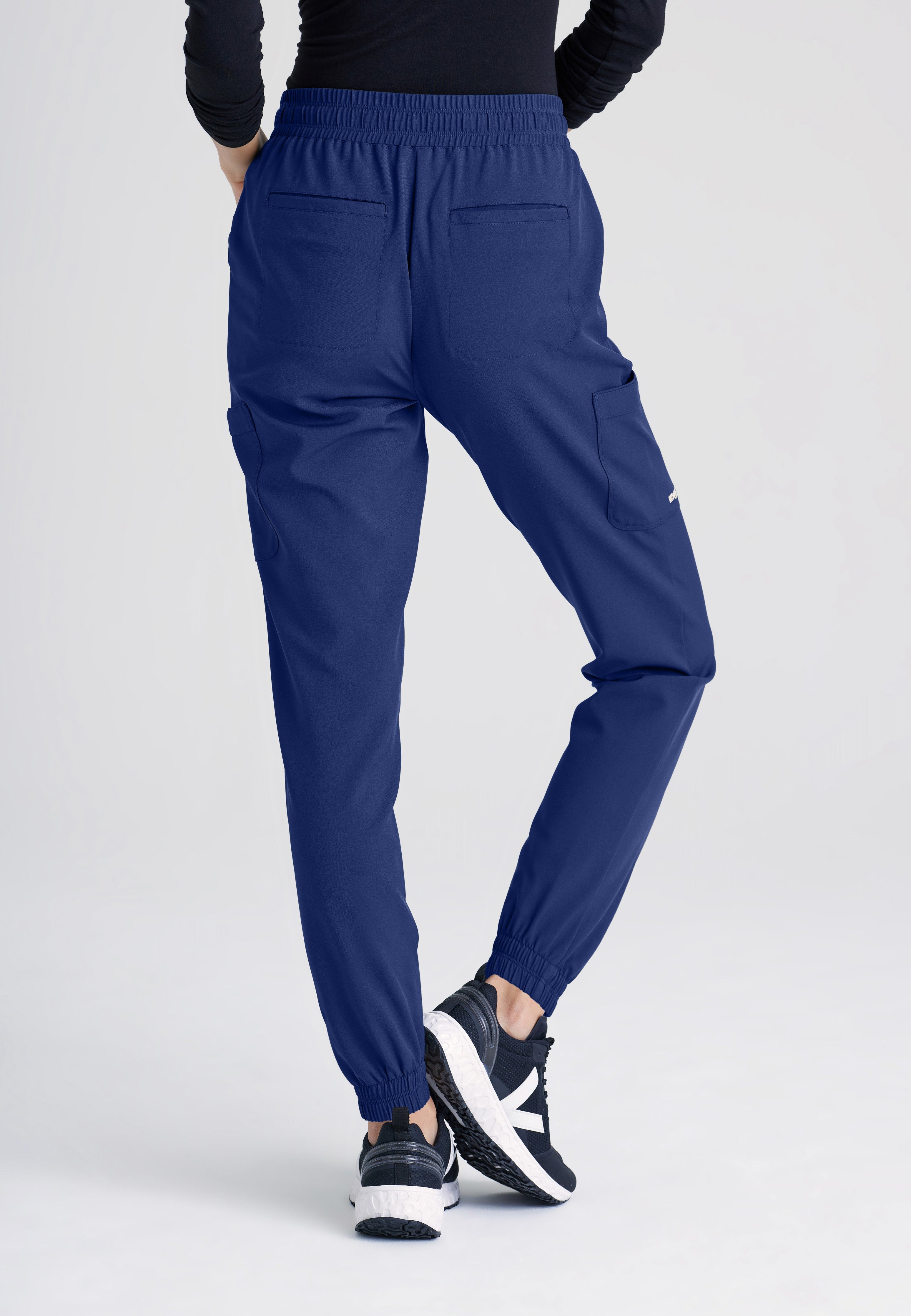 Back View of the Terra 6-Pocket Mid-Rise Ciclo® Jogger Scrub Pant in Indigo from Grey's Anatomy™ by Barco Evolve