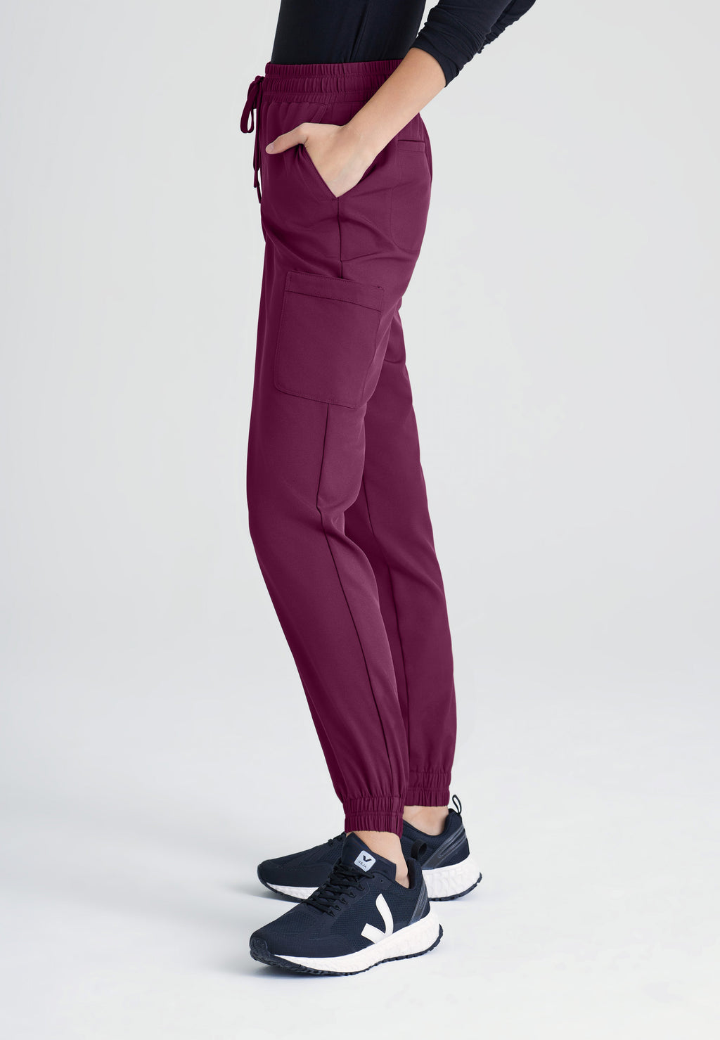 Side View of the Terra 6-Pocket Mid-Rise Ciclo® Jogger Scrub Pant in Wine from Grey's Anatomy™ by Barco Evolve