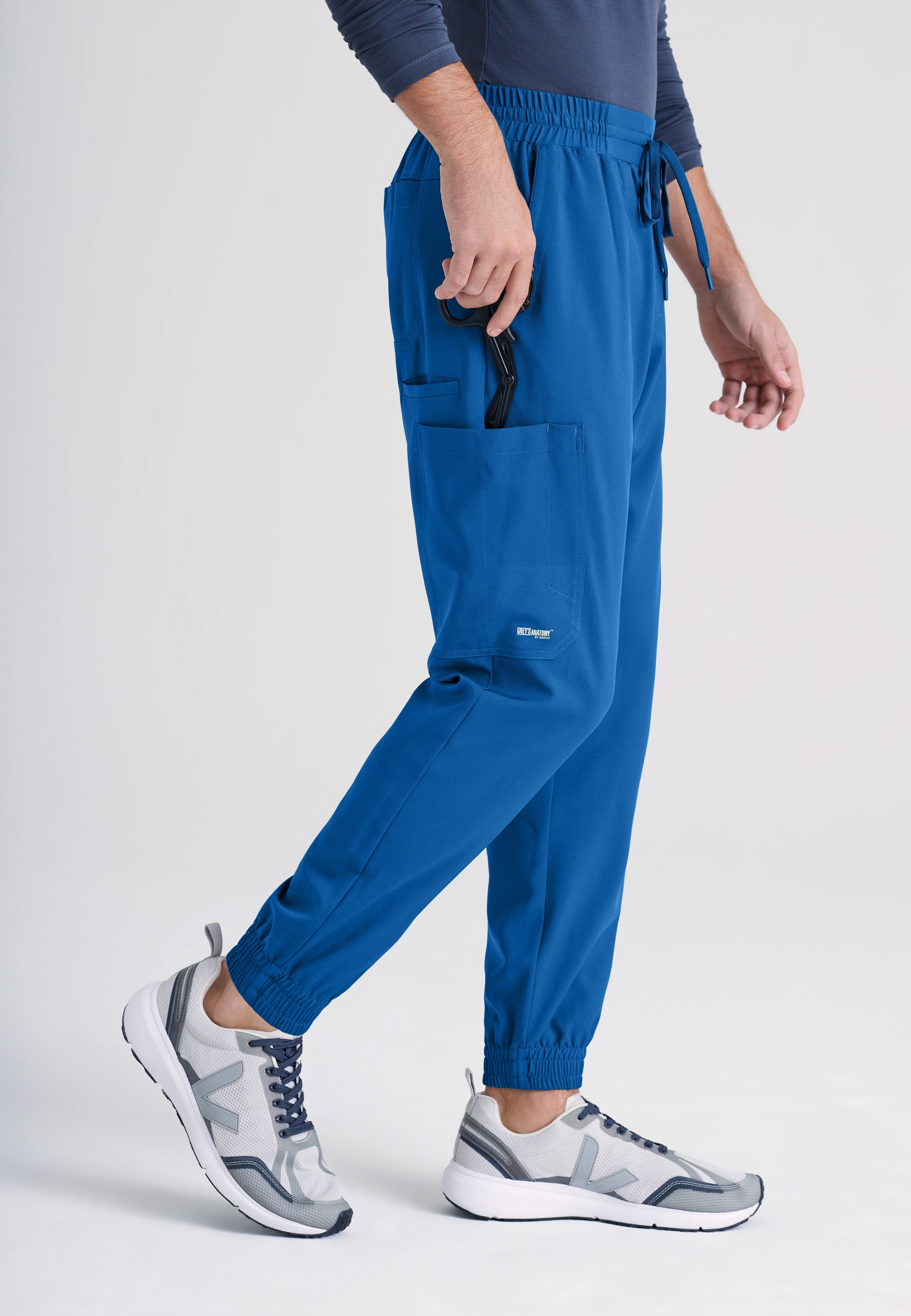 Side View of the Voyager 5-Pocket CICLO® Jogger Scrub Pant in New Royal from Grey's Anatomy™ by Barco Evolve