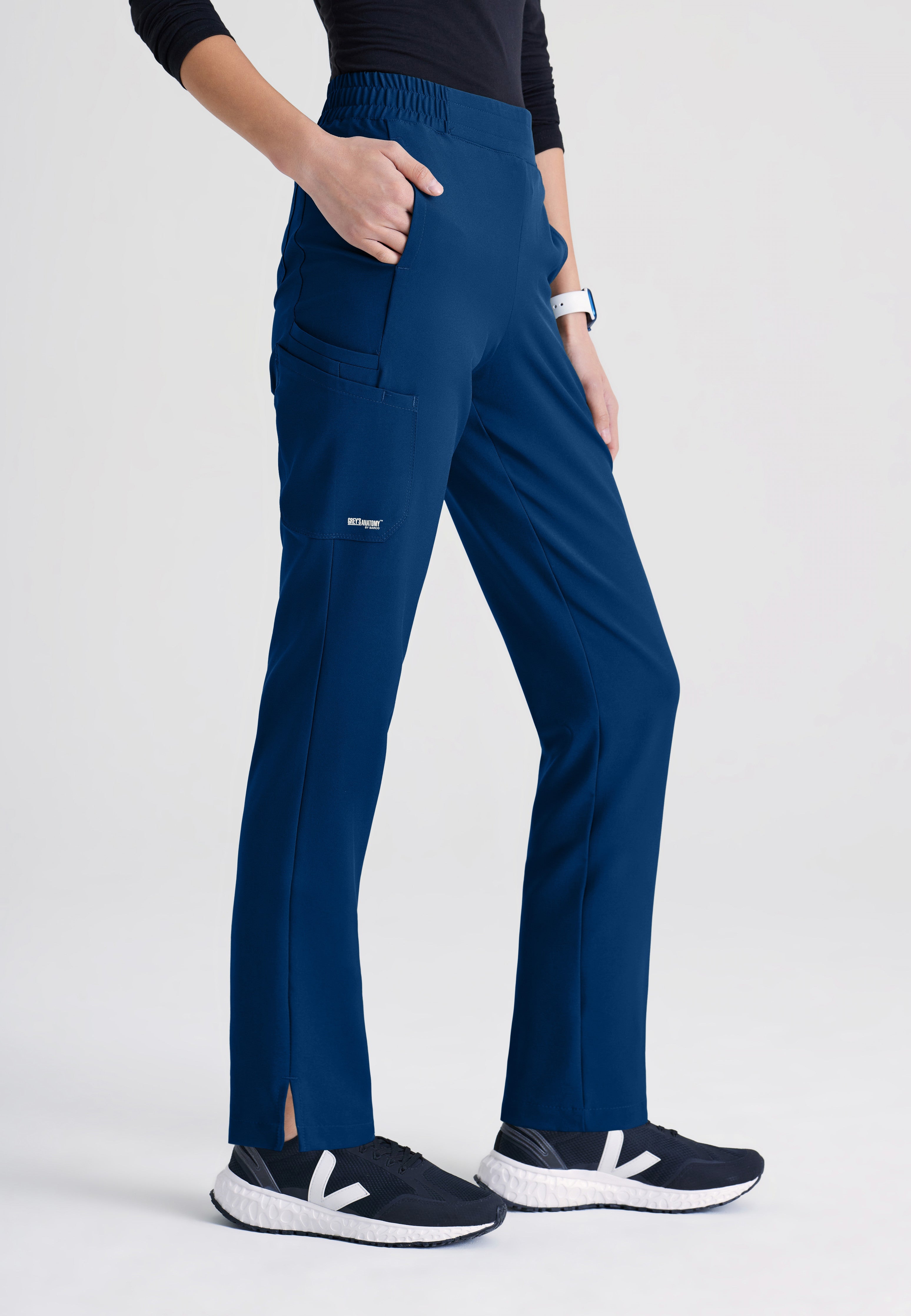 Side View of the Cosmo 6-Pocket Mid-Rise Tapered Leg Ciclo® Scrub Pant in Indigo from Grey's Anatomy™ by Barco Evolve