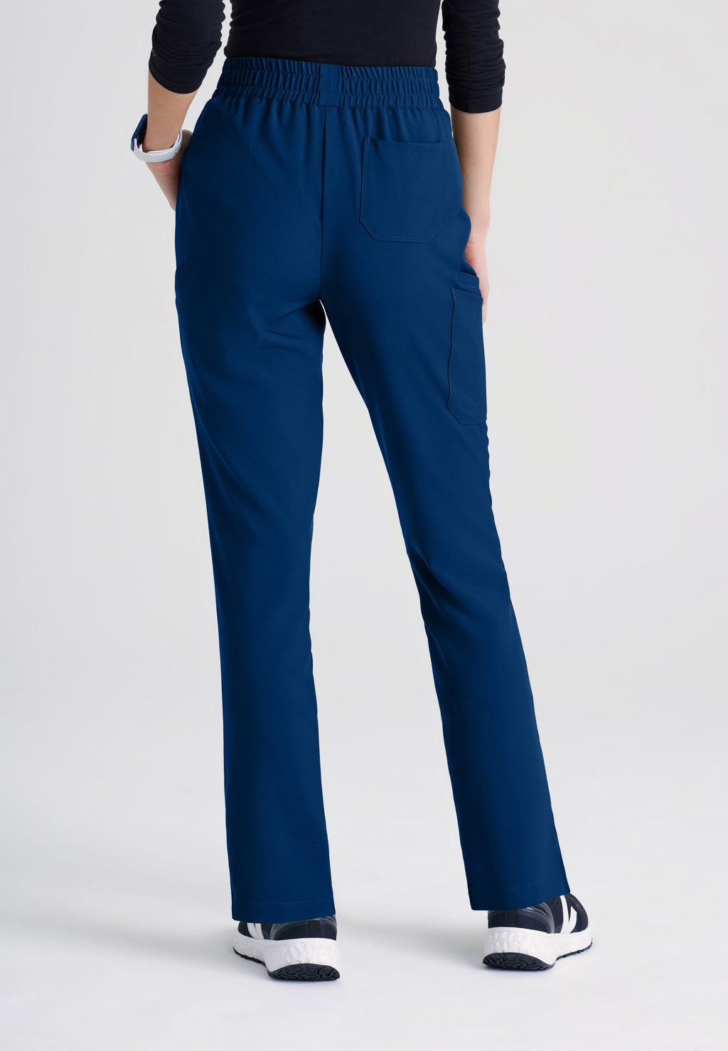 Back View of the Cosmo 6-Pocket Mid-Rise Tapered Leg Ciclo® Scrub Pant in Indigo from Grey's Anatomy™ by Barco Evolve