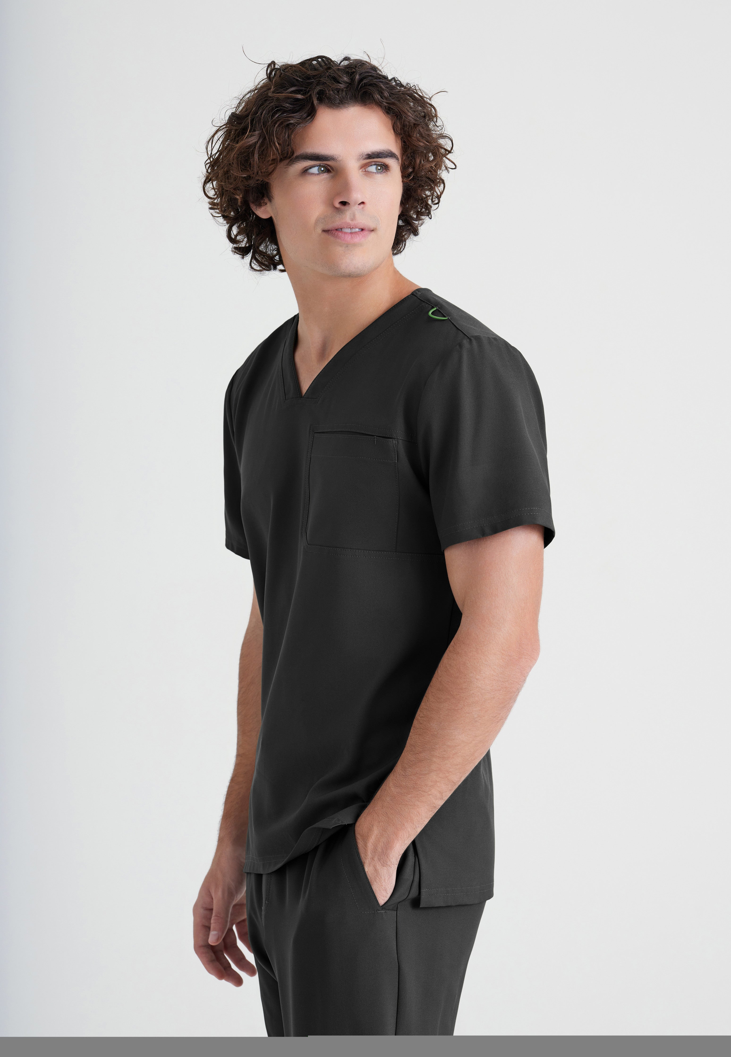 Side View of the Journey 1-Pocket Ciclo® Scrub Top in Black from Grey's Anatomy™ by Barco Evolve