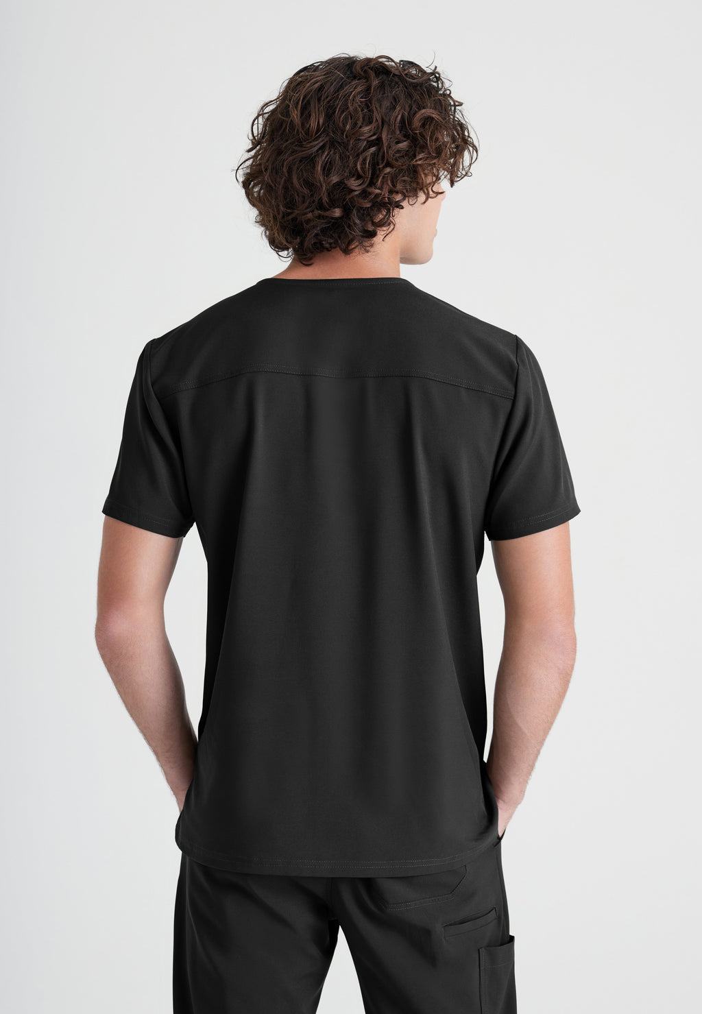 Back View of the Journey 1-Pocket Ciclo® Scrub Top in Black from Grey's Anatomy™ by Barco Evolve