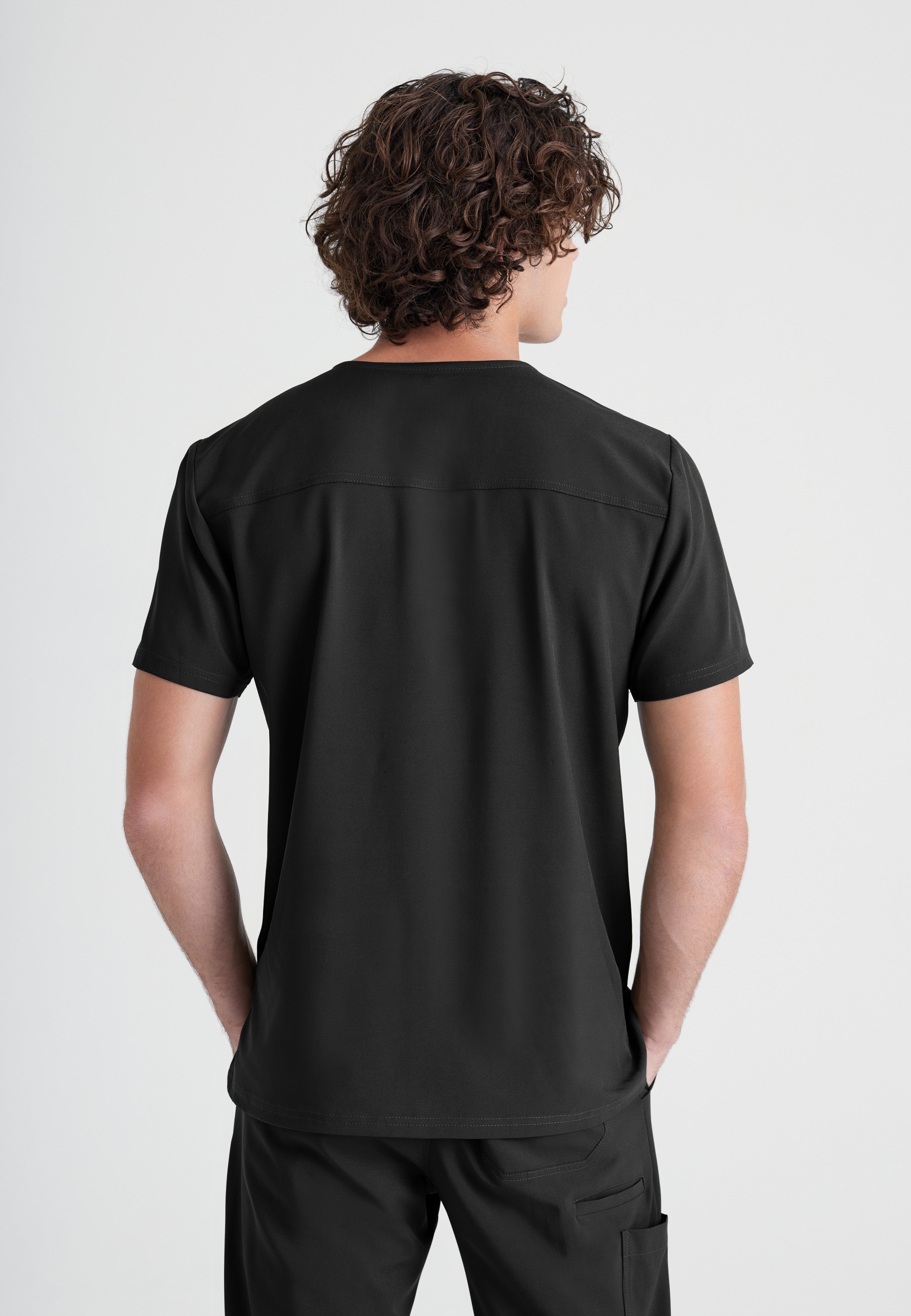 Back View of the Journey 1-Pocket Ciclo® Scrub Top in Black from Grey's Anatomy™ by Barco Evolve