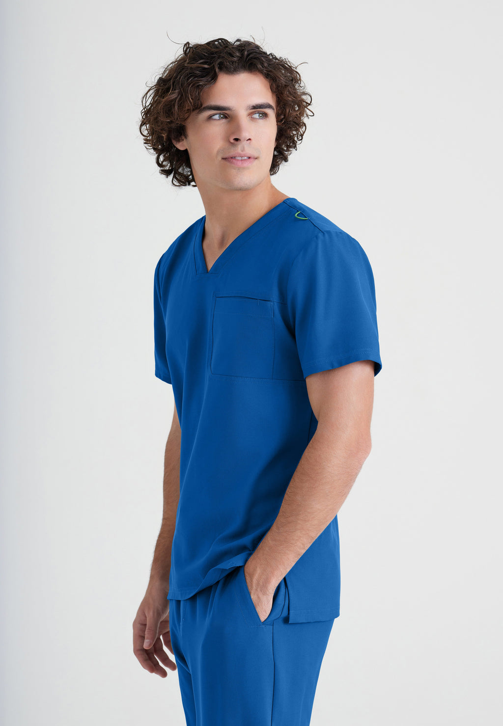 Side View of the Journey 1-Pocket Ciclo® Scrub Top in New Royal from Grey's Anatomy™ by Barco Evolve