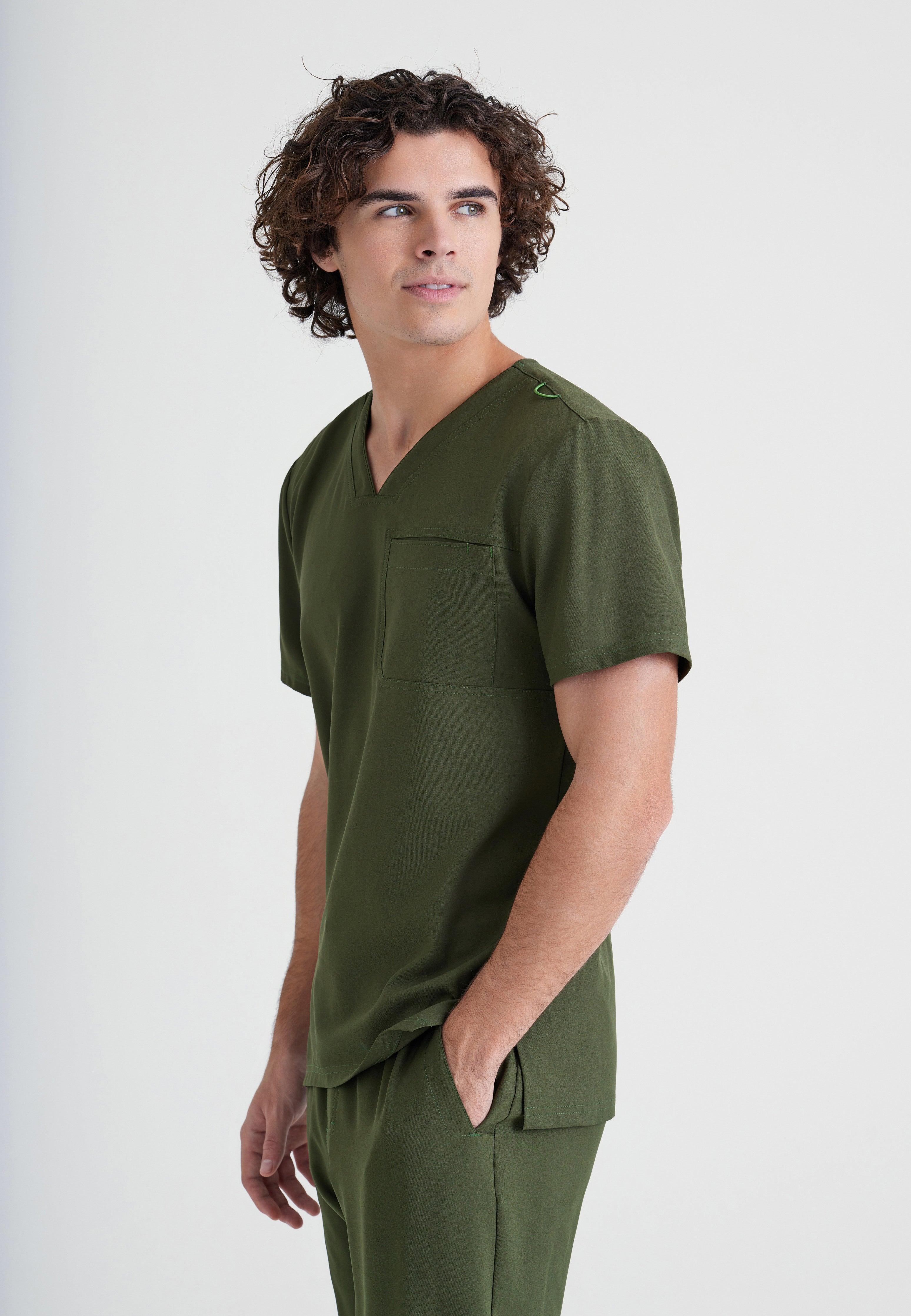 Side View of the Journey 1-Pocket Ciclo® Scrub Top in Indigo from Grey's Anatomy™ by Barco Evolve