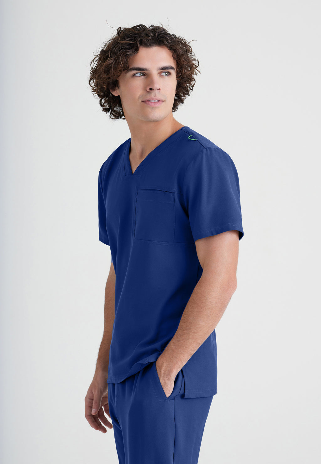 Side View of the Journey 1-Pocket Ciclo® Scrub Top in Indigo from Grey's Anatomy™ by Barco Evolve