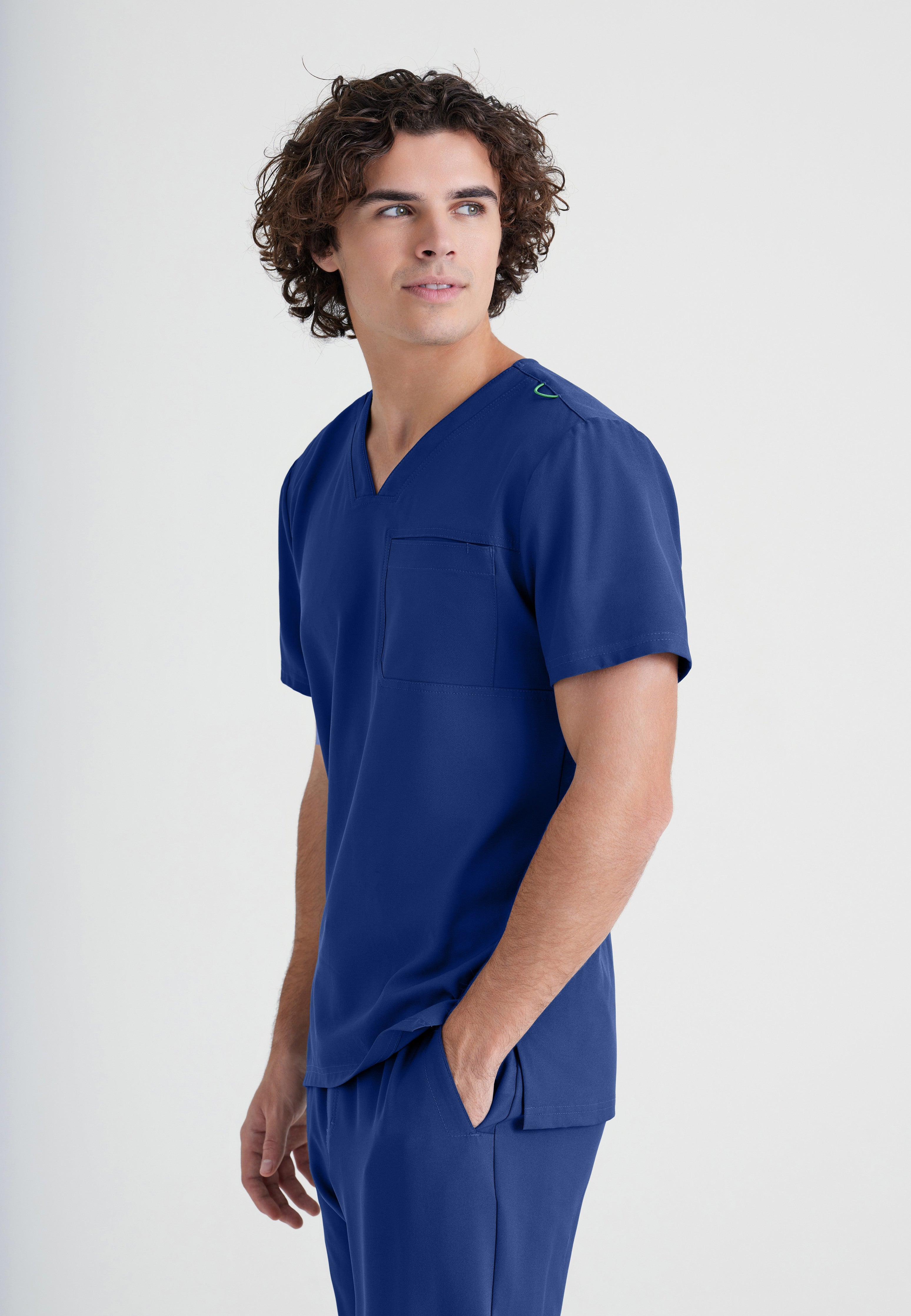 Side View of the Journey 1-Pocket Ciclo® Scrub Top in Indigo from Grey's Anatomy™ by Barco Evolve