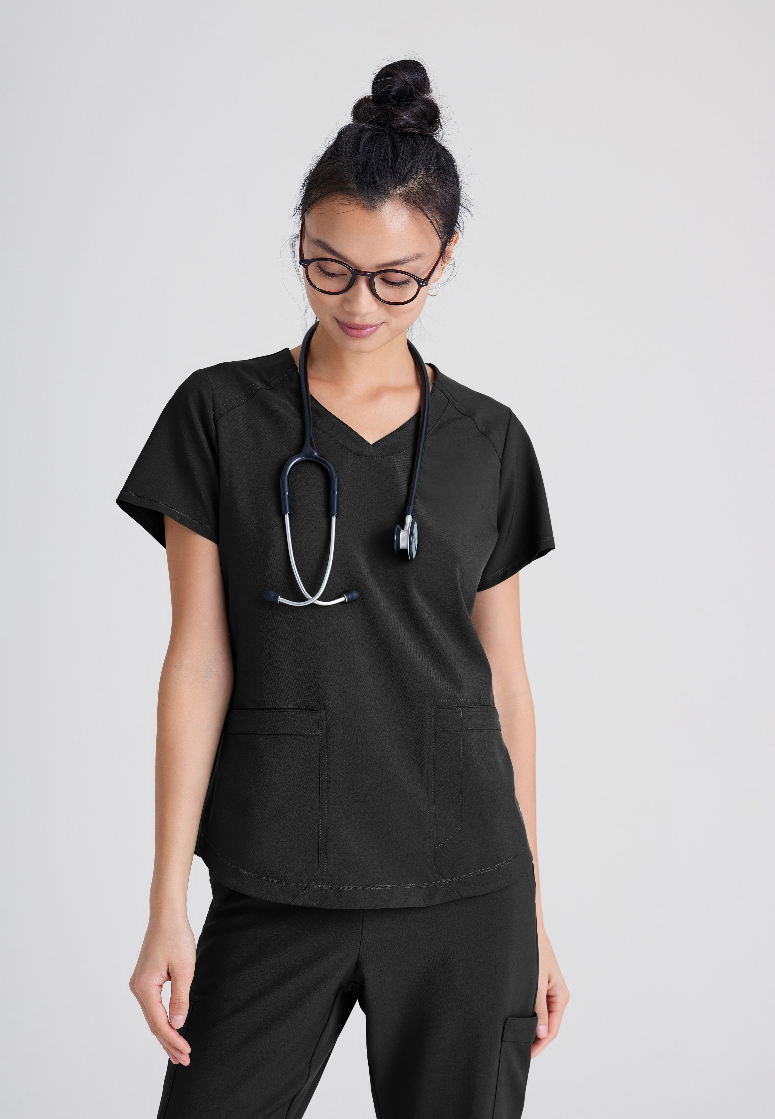 Front View of the Rhythm 2-Pocket Ciclo® Scrub Top in Black from Grey's Anatomy™ by Barco Evolve