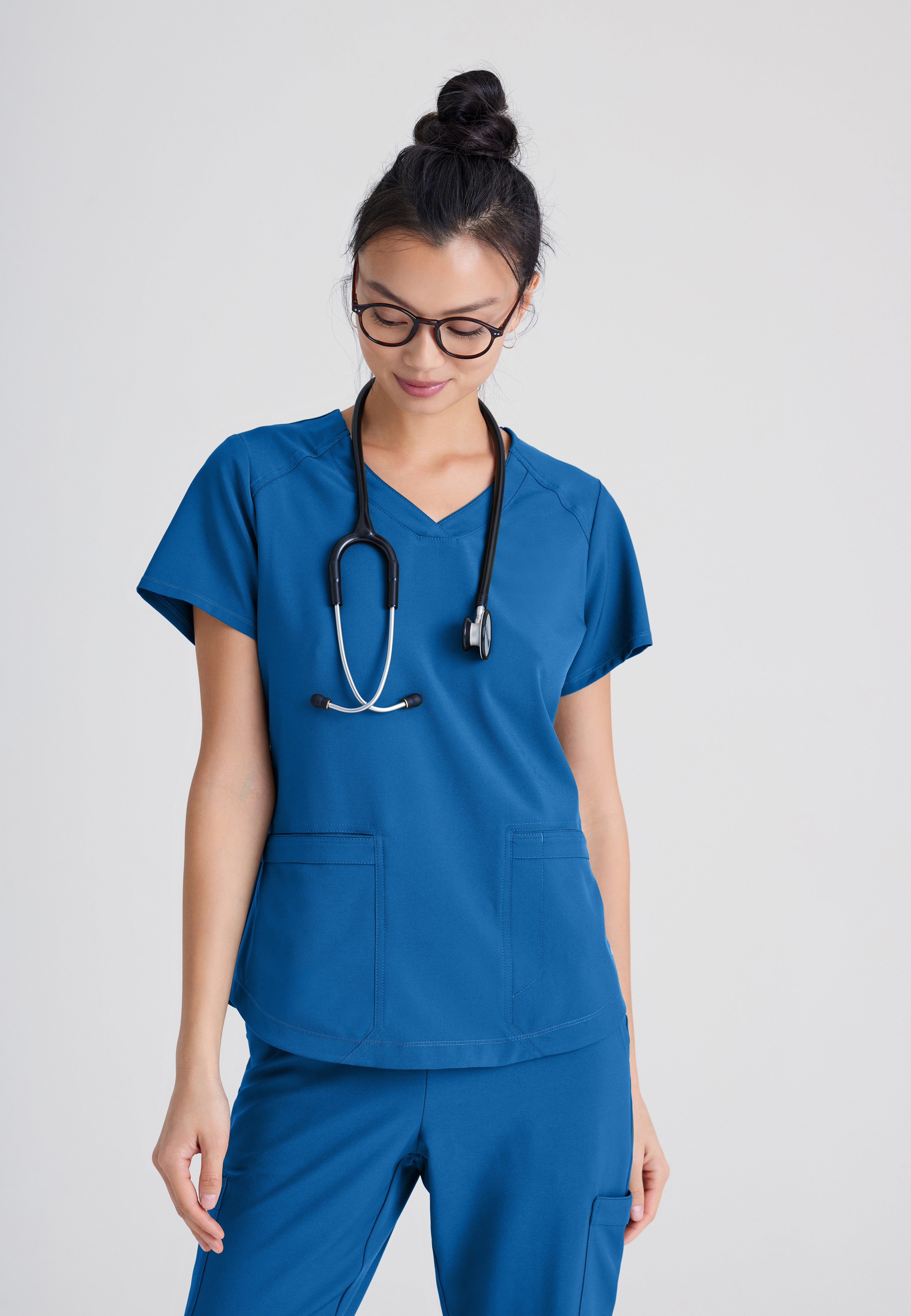 Front View of the Rhythm 2-Pocket Ciclo® Scrub Top in New Royal from Grey's Anatomy™ by Barco Evolve