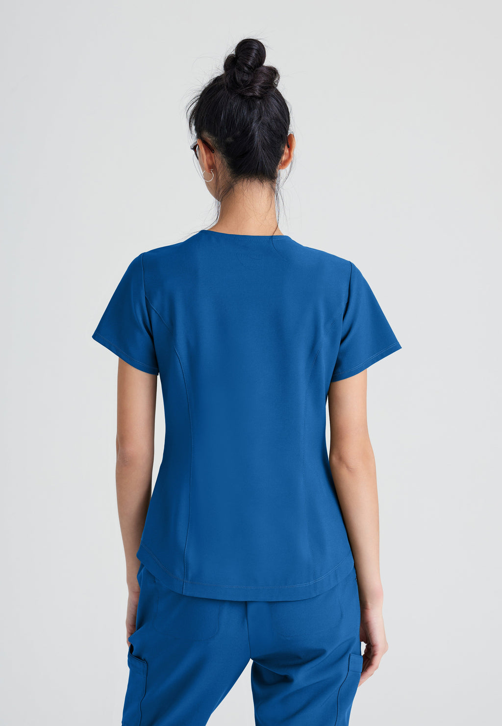 Back View of the Rhythm 2-Pocket Ciclo® Scrub Top in New Royal from Grey's Anatomy™ by Barco Evolve