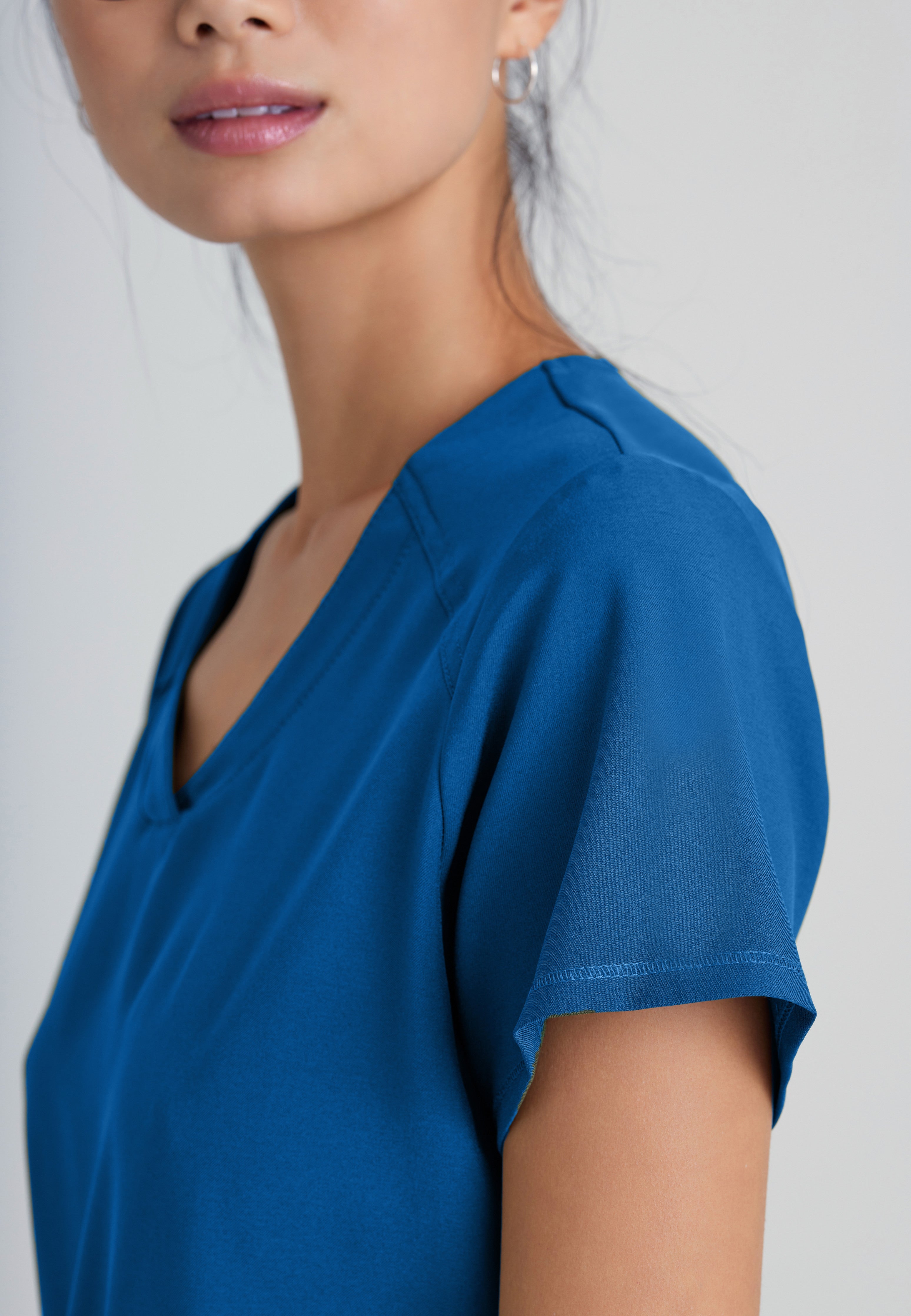 Detail Shot of the Rhythm 2-Pocket Ciclo® Scrub Top in New Royal from Grey's Anatomy™ by Barco Evolve