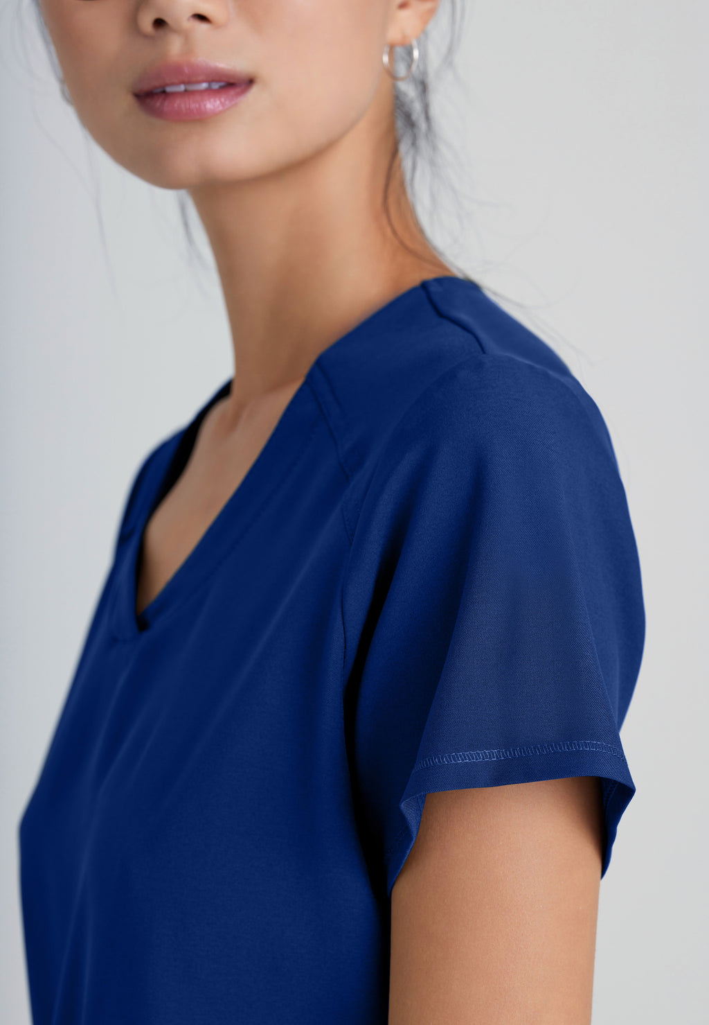 Detail Shot of the Rhythm 2-Pocket Ciclo® Scrub Top in Indigo from Grey's Anatomy™ by Barco Evolve
