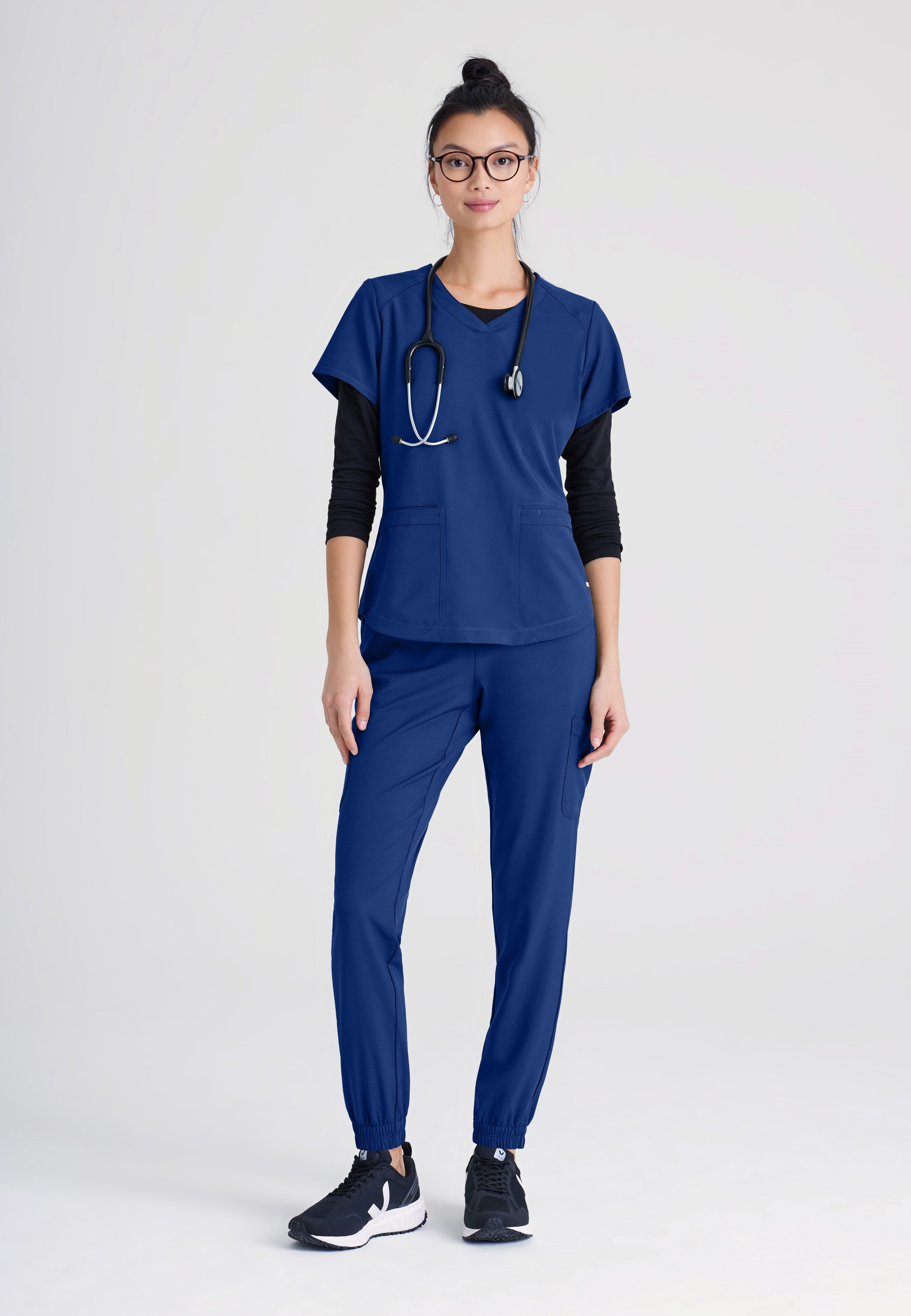 Full Body View of the Terra 6-Pocket Mid-Rise Ciclo® Jogger Scrub Pant in Indigo from Grey's Anatomy™ by Barco Evolve
