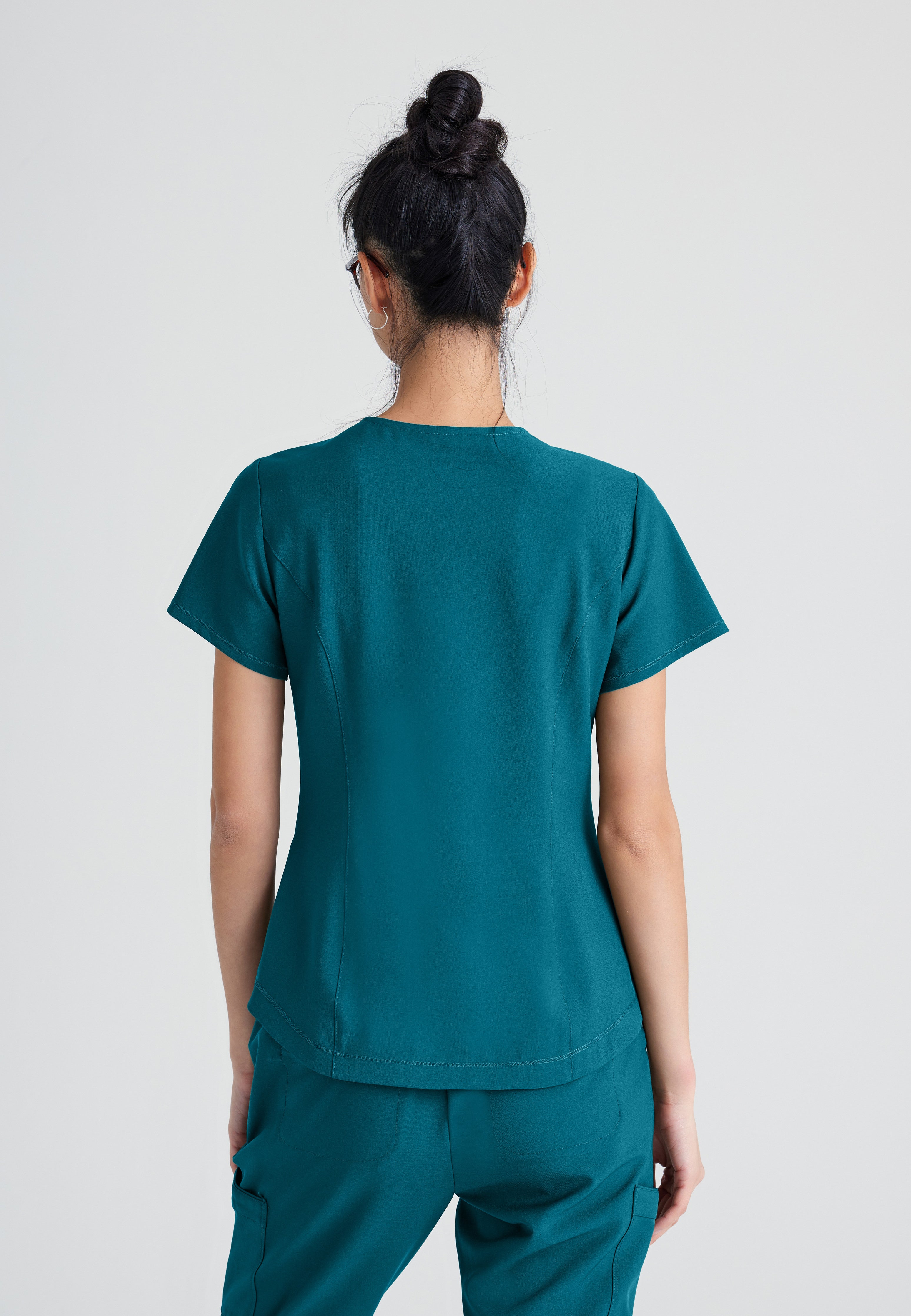 Back View of the Rhythm 2-Pocket Ciclo® Scrub Top in Bahama from Grey's Anatomy™ by Barco Evolve