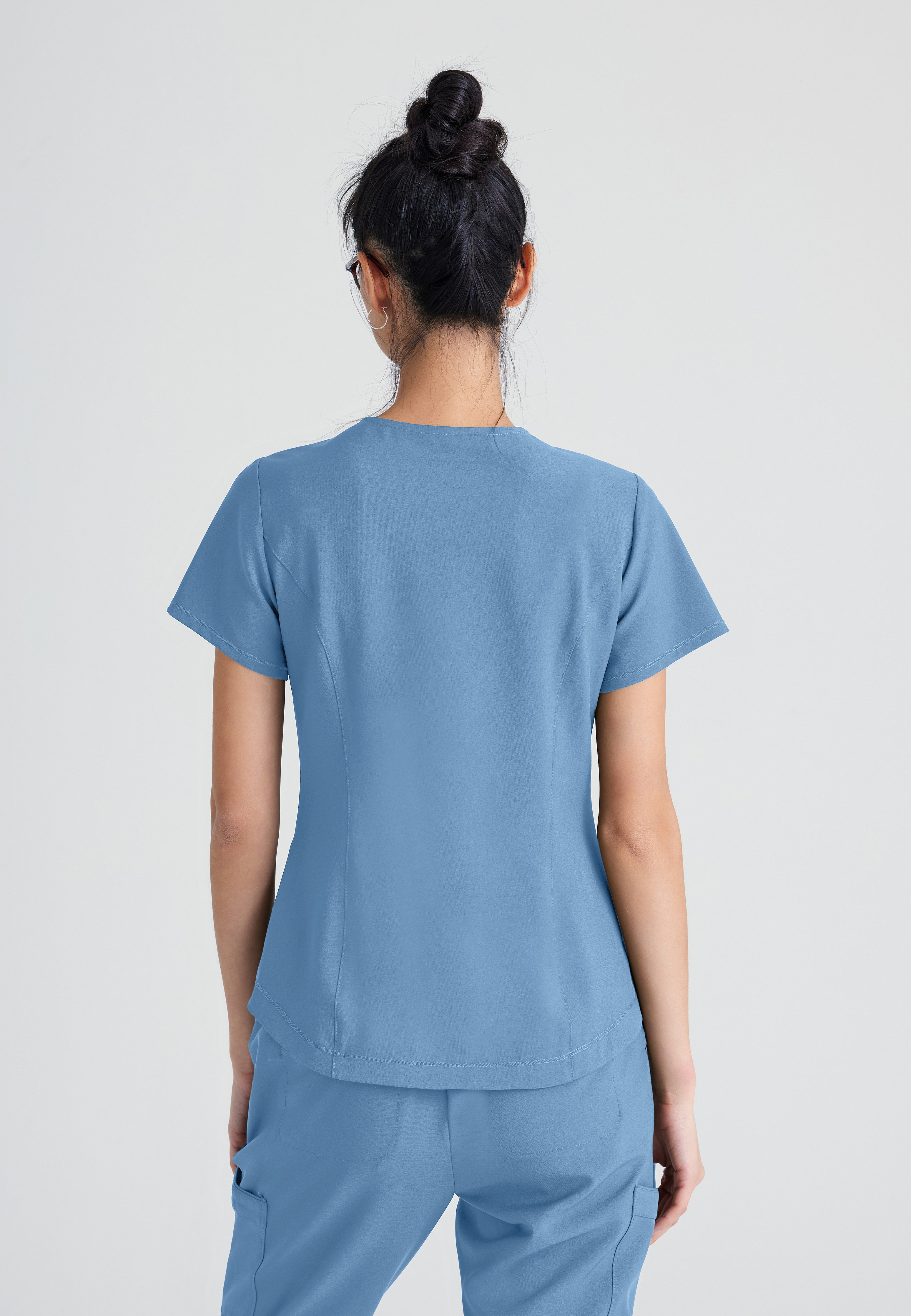 Back View of the Rhythm 2-Pocket Ciclo® Scrub Top in Ciel Blue from Grey's Anatomy™ by Barco Evolve