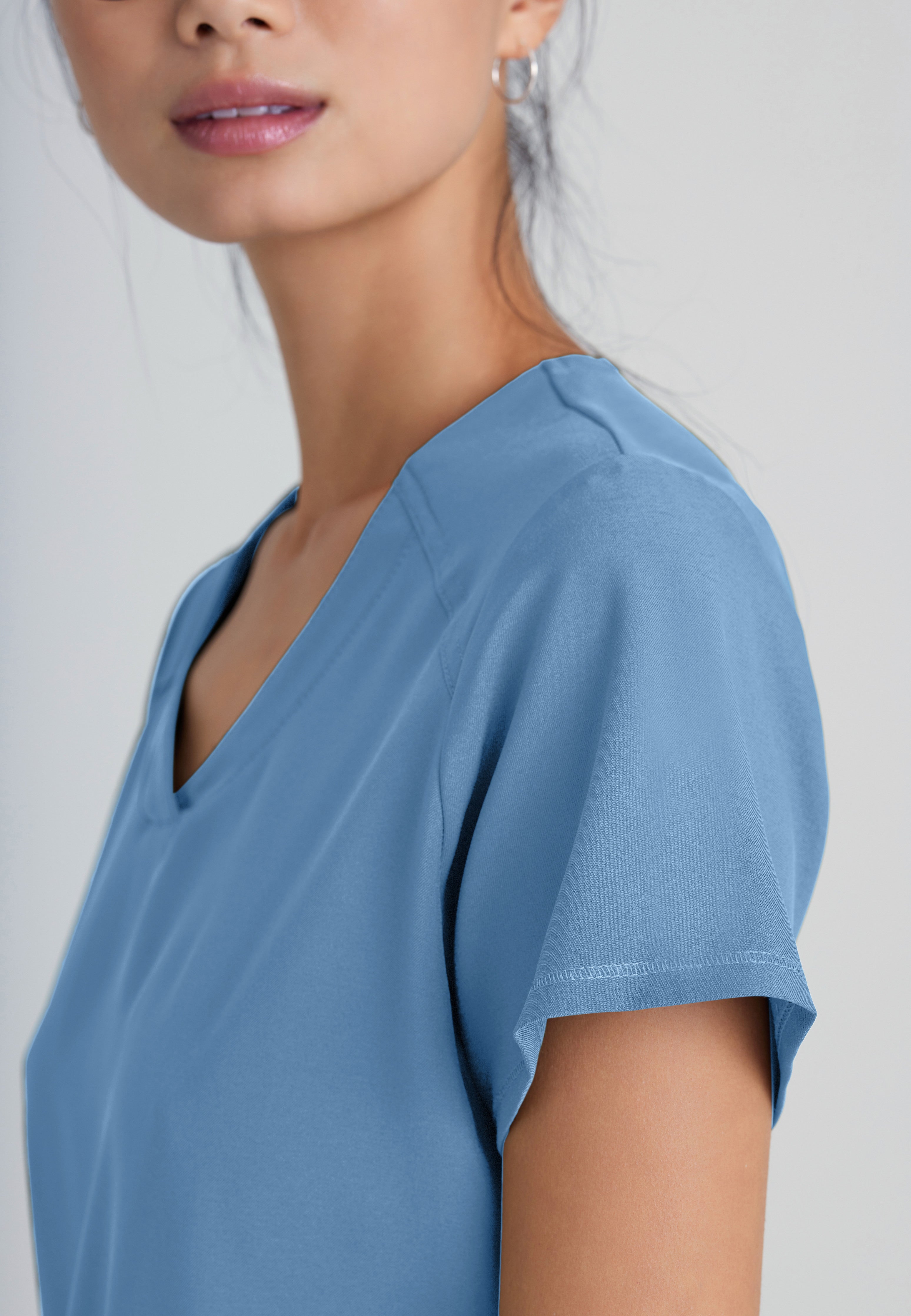 Detail Shot of the Rhythm 2-Pocket Ciclo® Scrub Top in Ciel Blue from Grey's Anatomy™ by Barco Evolve