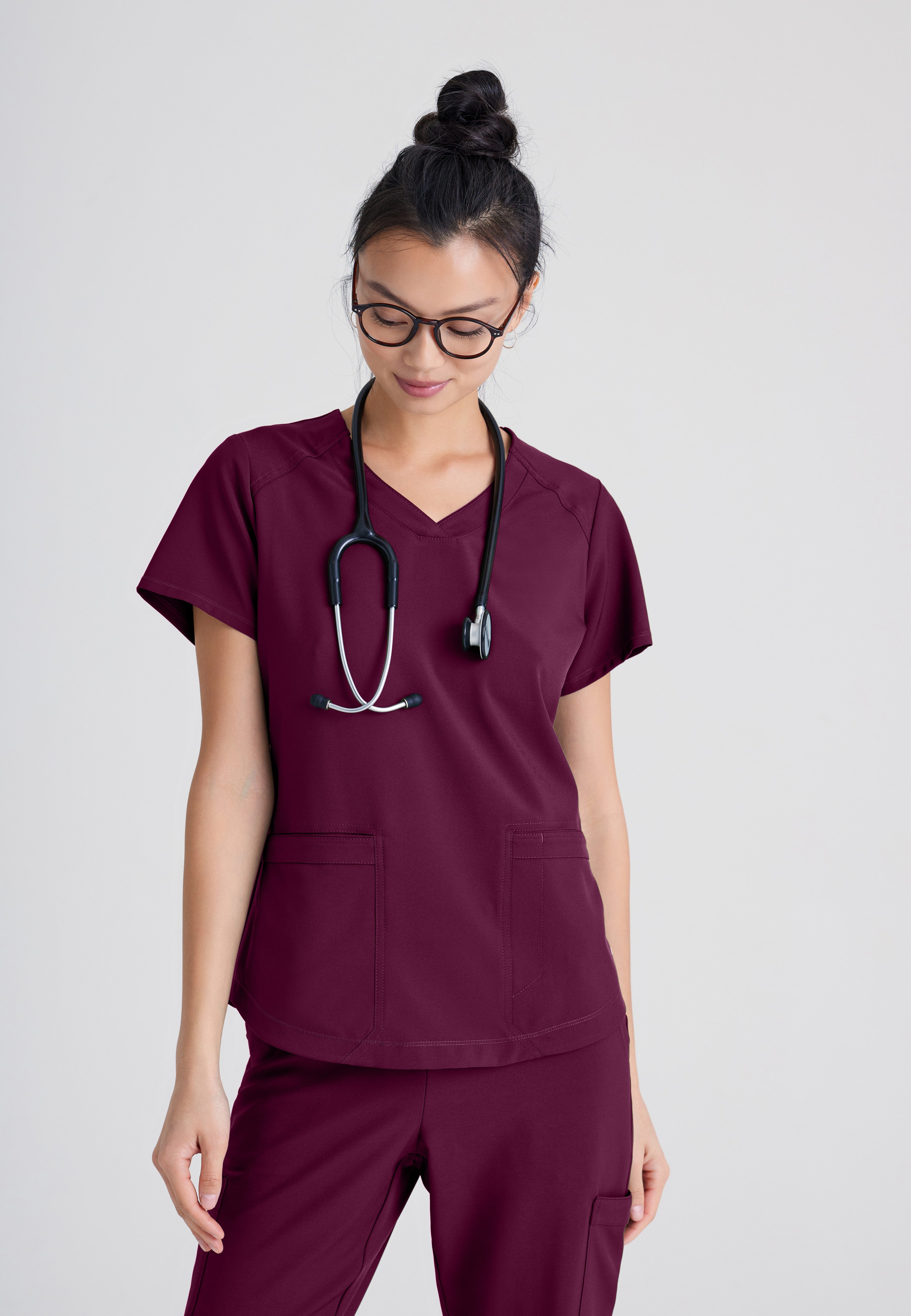 Front View of the Rhythm 2-Pocket Ciclo® Scrub Top in Wine from Grey's Anatomy™ by Barco Evolve