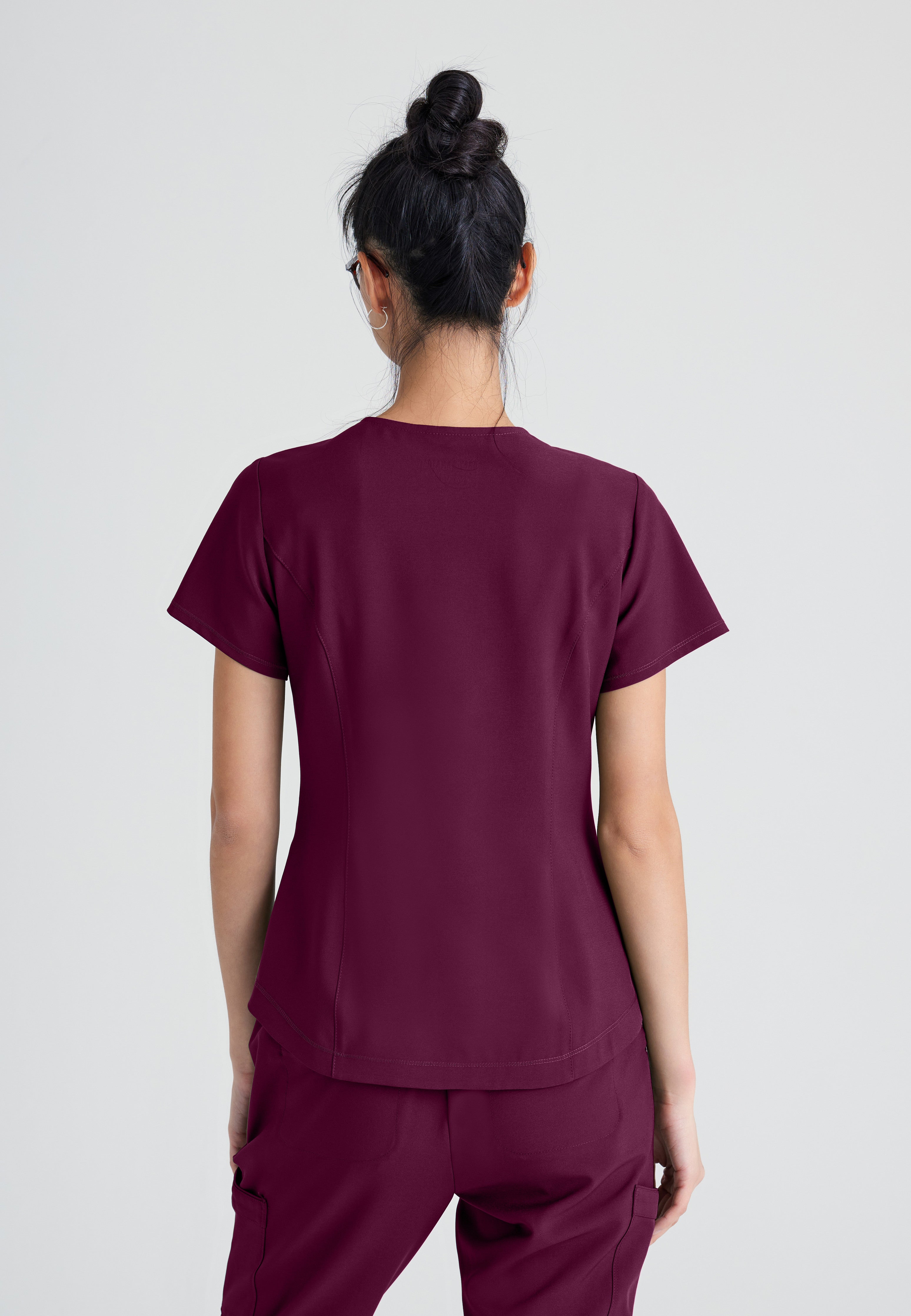 Back View of the Rhythm 2-Pocket Ciclo® Scrub Top in Wine from Grey's Anatomy™ by Barco Evolve